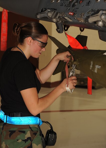 Senior Airman Sheron Boothe, 334th Aircraft Maintenance Unit loadmaster, tightens the screws on a MK-82 bomb during a load crew competition on Seymour Johnson Air Force Base, N.C., July 17, 2009. The competition is held quarterly and also annually for the Weapons Load crew of the year. (U.S. Air Force photo by Senior Airman Ciara Wymbs)   