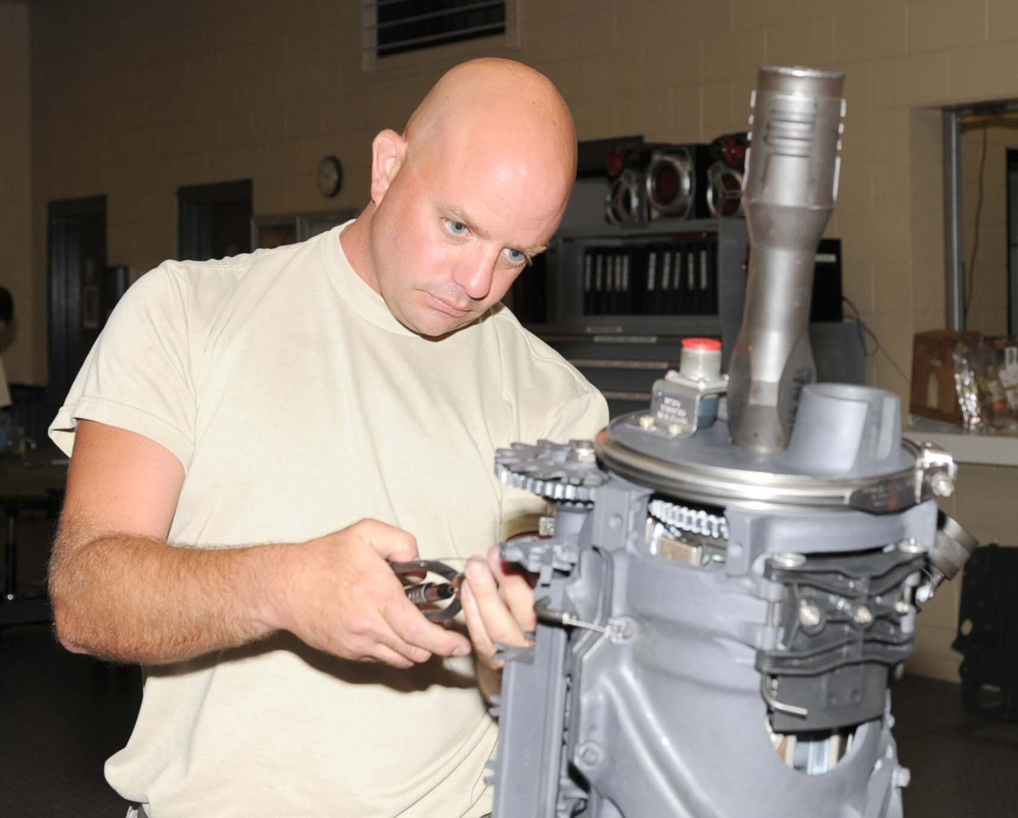 Tech. Sgt. Jason Althoff, 4th Equipment Maintenance Squadron armament shift superintendent, attaches safety wiring to an M61A1 20mm Gatling gun at Seymour Johnson Air Force Base, N.C., July 24, 2009. The safety wire is attached to the fire mechanism portion of the M61A1 allowing it to function properly. (U.S. Air Force photo by Airman 1st Class Gino Reyes)