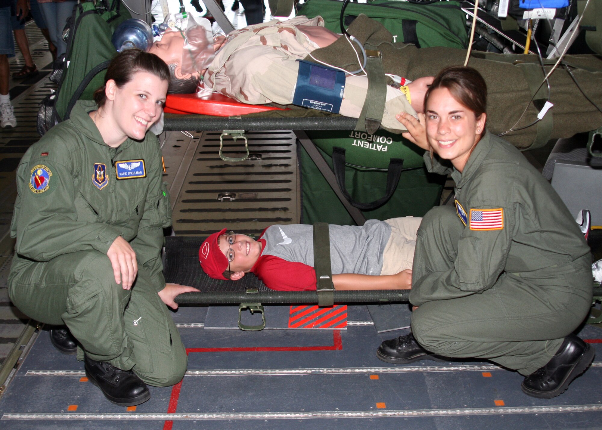 WRIGHT-PATTERSON AIR FORCE BASE, Ohio - 1st Lt. Katie Spellman and Staff Sgt. Anna Tall, both from the 445th Aeromedical Evacuation Squadron, demonstrate medical procedures to 9-year-old Derek Coverstone at the Dayton Air Show July18. The 445th AW's involvement also included a C-5 Galaxy flyover and 445 AW Reserve Recruiting talking with air show spectators. (U. S. Air Force photos/Staff Sgt. Ken LaRock)