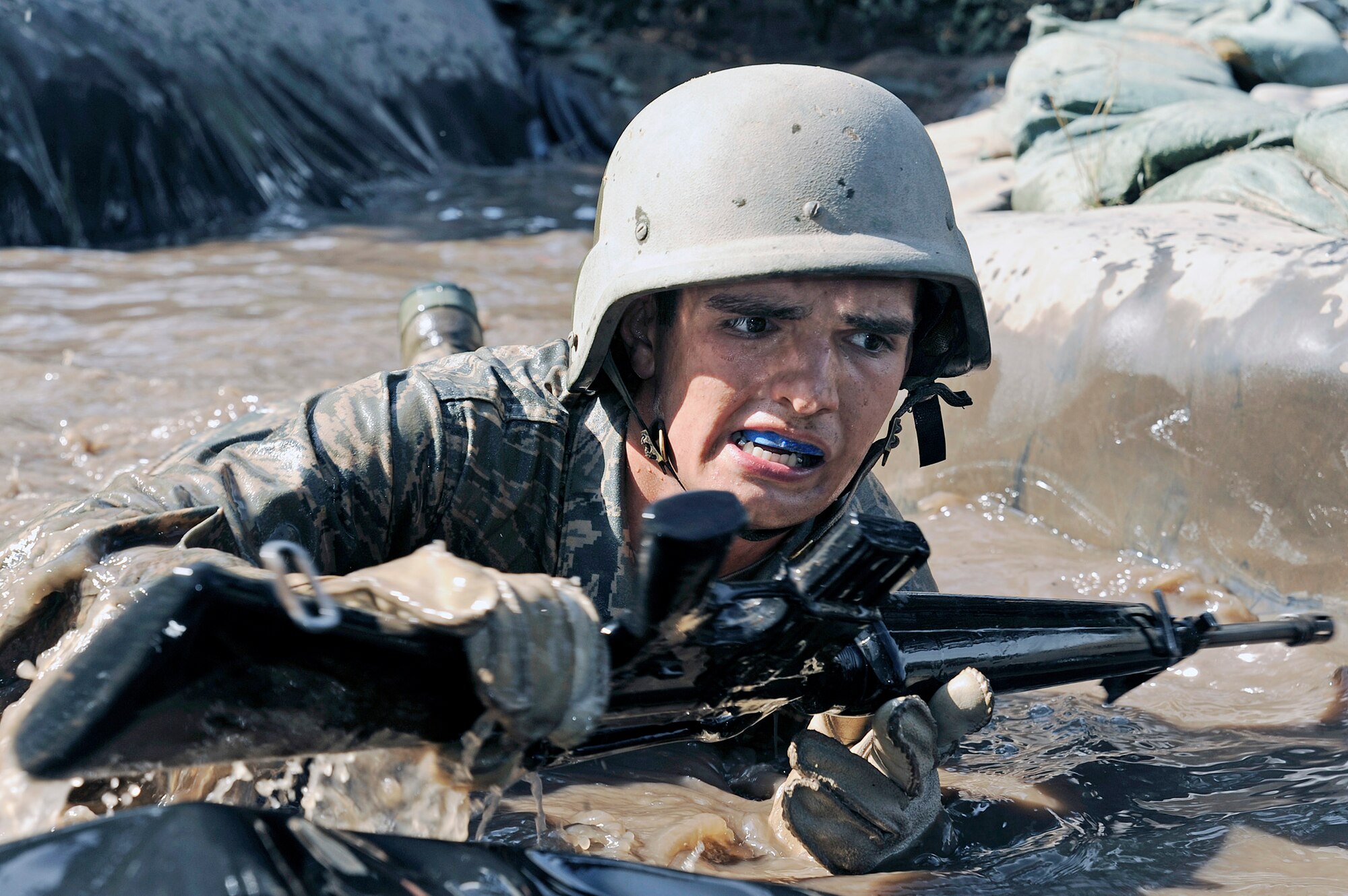 Air Force Academy Basic Cadet Evan Rowley pushes through the water obstacle at the Jacks Valley Assault Course July 21 near Colorado Springs, Colo.   Basic cadet training started June 25 and continues through Aug. 1.  (U.S. Air Force photo/Mike Kaplan)