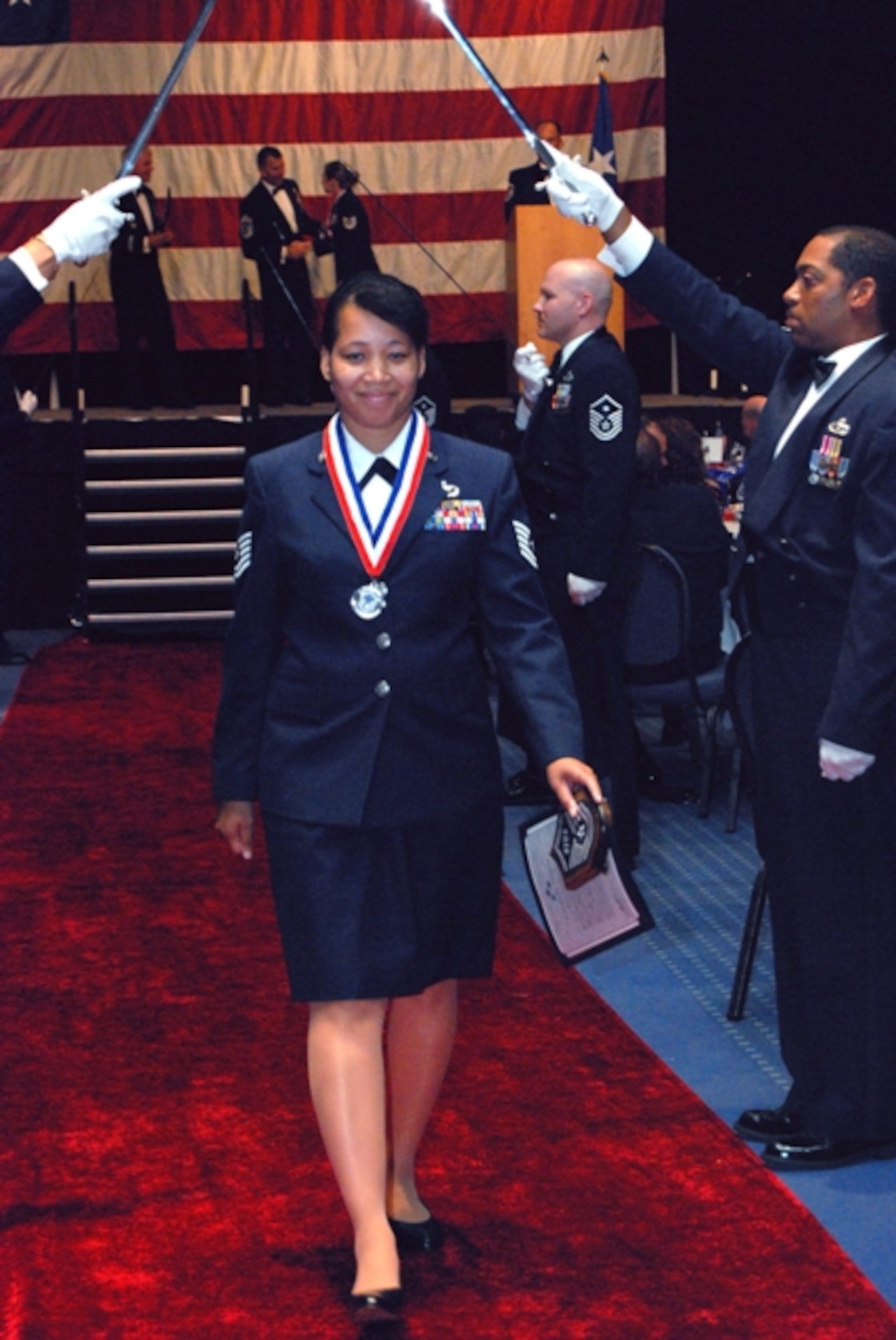 Tech. Sgt. Latoya Guardia of Detachment 9, Training Support
Squadron (Air Combat Command), walks under the traditional "arch of sabers"
during Team Eglin's senior NCO induction ceremony July 24 hosted by the base
Top 3. She is the instructional development NCO in charge of her unit that
creates and maintains training deliverables for total Air Force Control and
Reporting Centers and Air Control Systems. The sergeant looks forward to her promotion next spring. (Courtesy photo)

