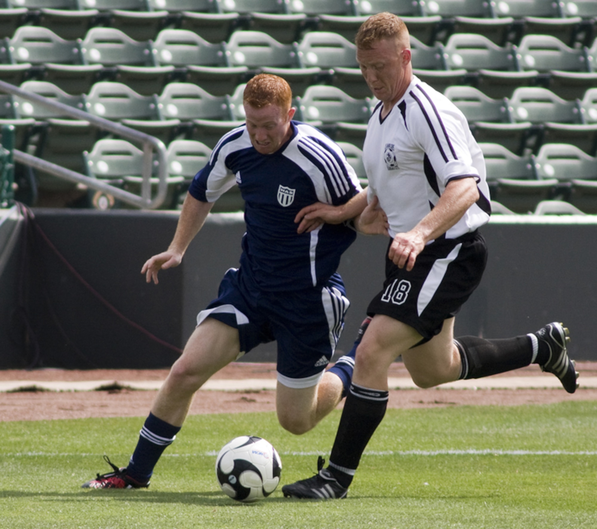 KANSAS CITY, Mo. – A member of Whiteman’s Varsity Soccer Team (blue jersey) attempts to steal the soccer ball from an opponent July 4 during a game against the Marine Varsity Team from Richards-Gebaur Memorial Airport. Whiteman topped Richards-Gebaur with a score of 11-2. (U.S. Air Force photo/Capt. Allen Clark)