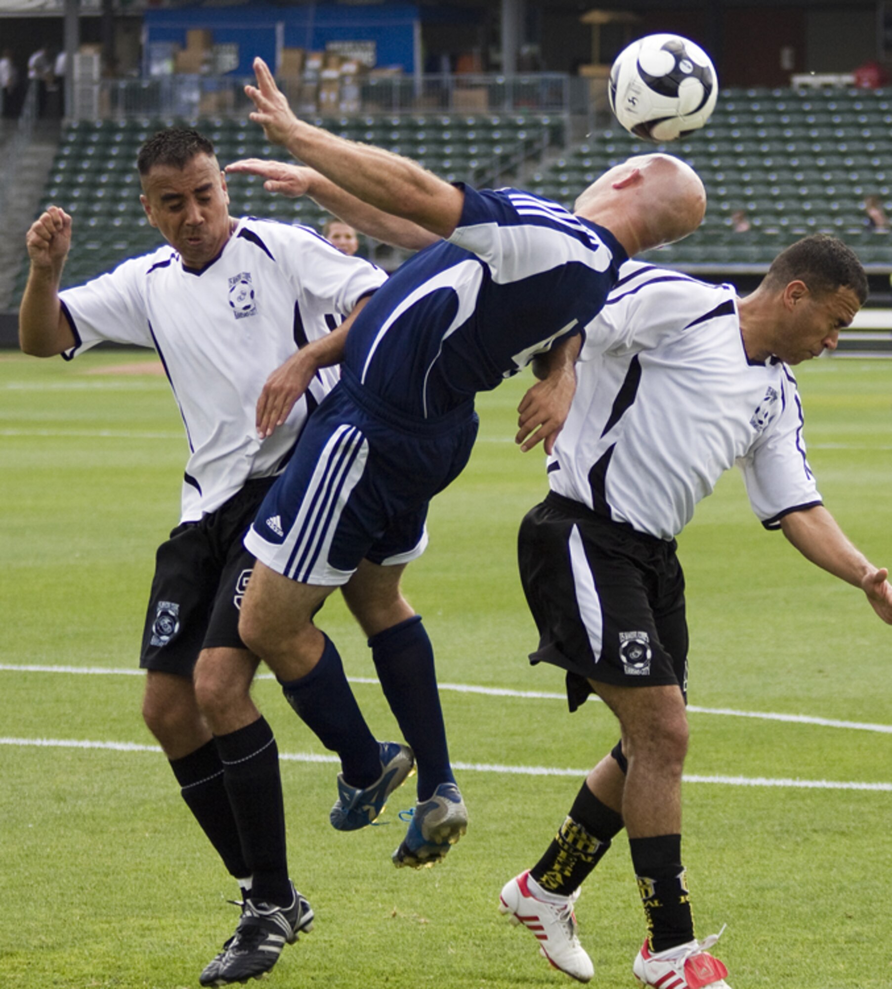 KANSAS CITY, Mo. – A member of Whiteman’s Varsity Soccer Team (blue jersey) pinches between two opponents for the soccer ball July 4 during a game against the Marine Varsity Team from Richards-Gebaur Memorial Airport. Whiteman topped Richards-Gebaur with a score of 11-2. (U.S. Air Force photo/Capt. Allen Clark)