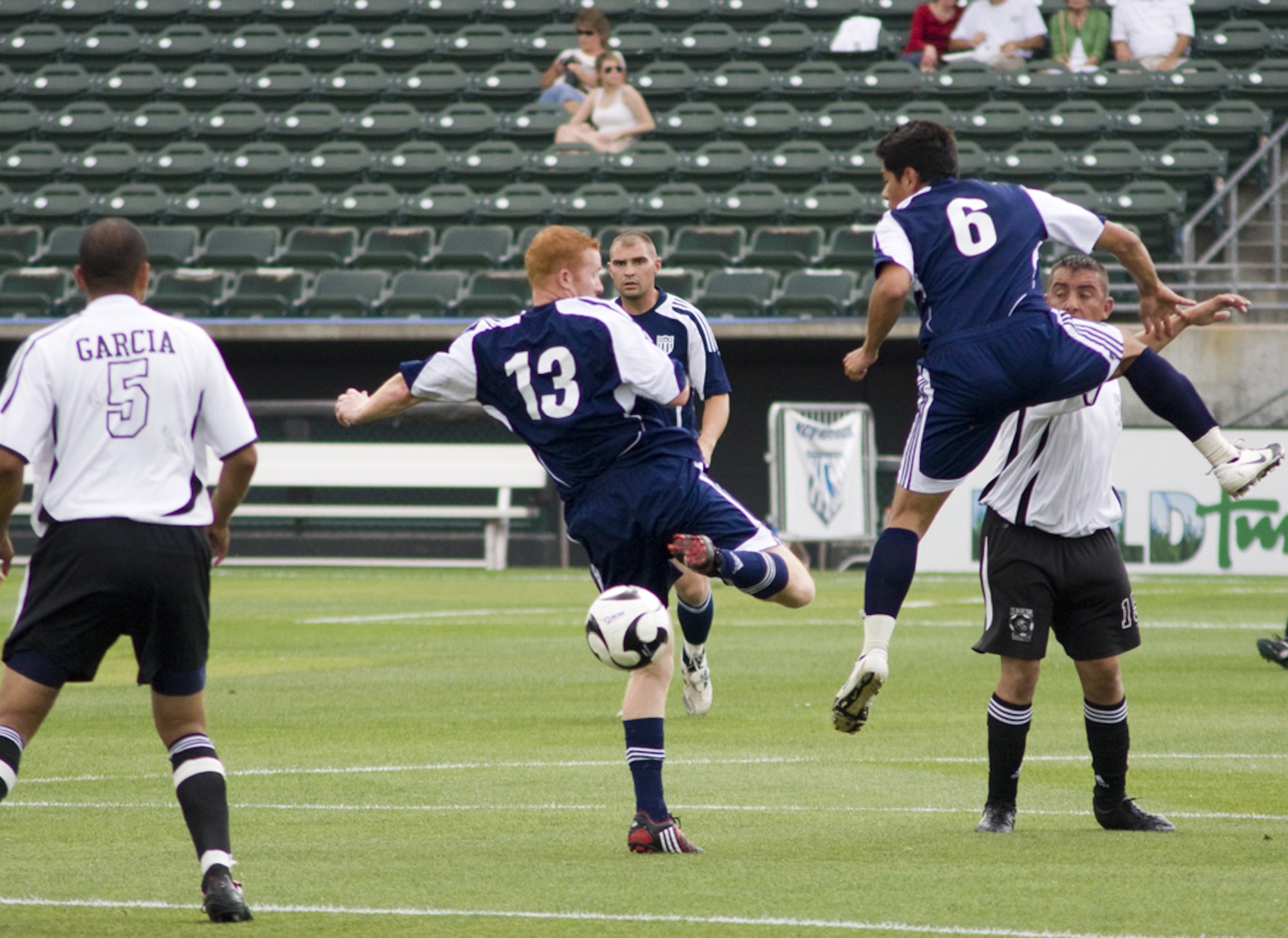 KANSAS CITY, Mo. – A member of Whiteman’s Varsity Soccer Team (blue jersey) attempts to move around his opponent July 4 during a game against the Marine Varsity Team from Richards-Gebaur Memorial Airport. Whiteman topped Richards-Gebaur with a score of 11-2. (U.S. Air Force photo/Capt. Allen Clark)
