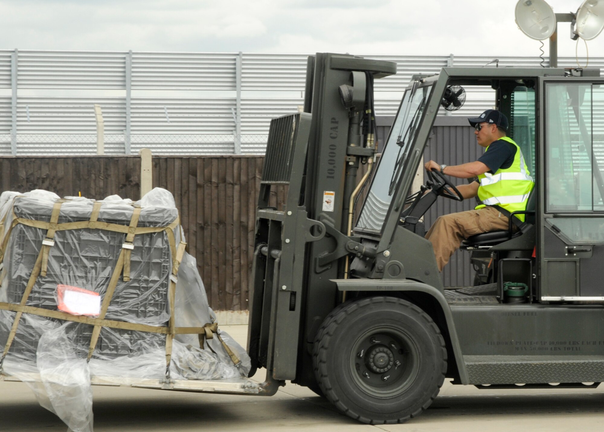 Luis Vega-Reyes, 48th Logistics Readiness Squadron turn-in manager, moves a pallet onto a conveyer belt to be signed off and approved for shipment July 22, 2009 at RAF Lakenheath, England. Pallet building is an important part of pre-deployment and regular shipment of Air Force goods. (U.S. Air Force photo/Airman 1st Class Eboni Knox)