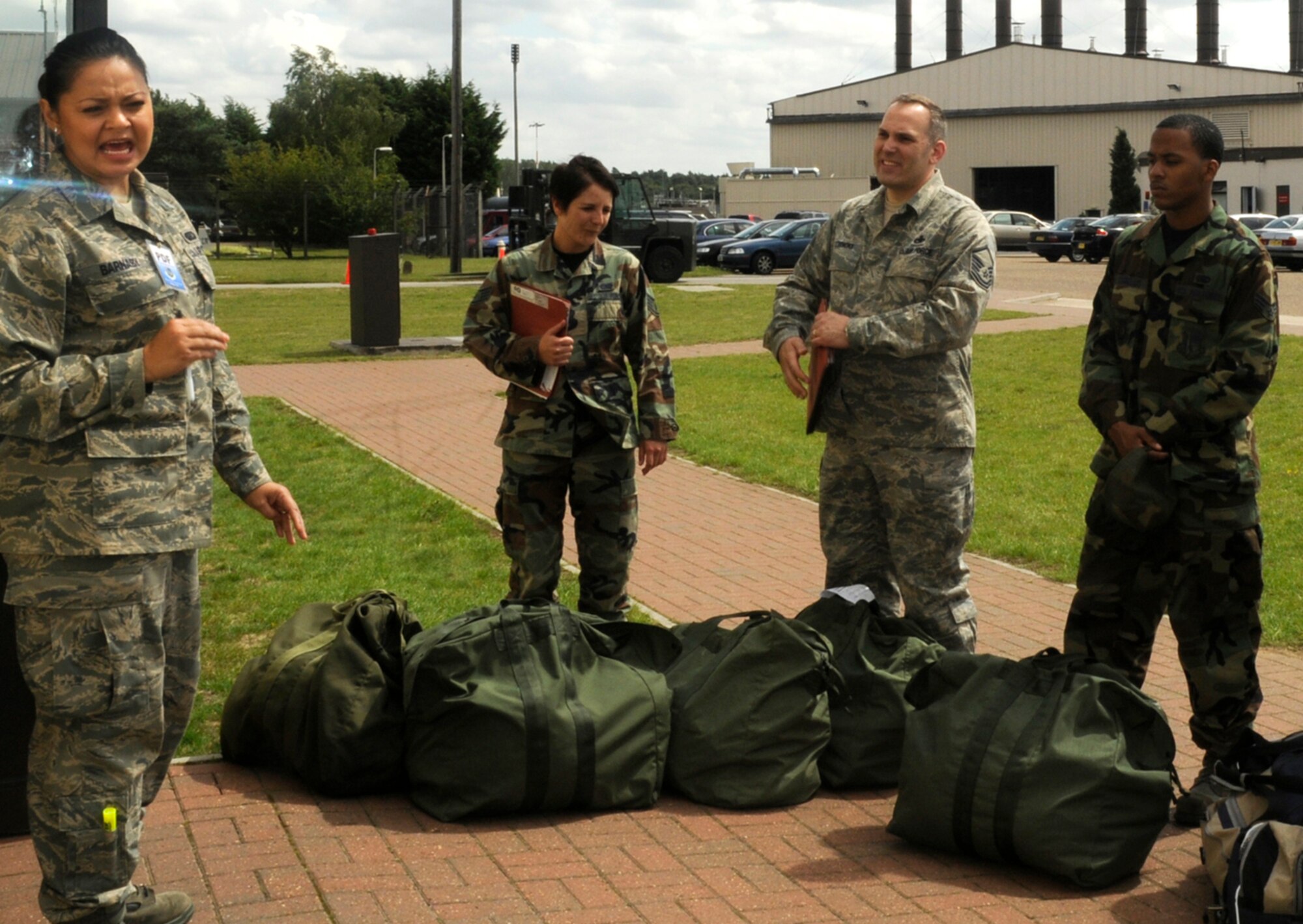 Airman 1st Class Jenniepher Barnaby, 48th Force Support Squadron commander’s secretary, briefs Airmen on their mock pre-deployment processing stages before they enter the Personnel Deployment Facility July 22, 2009 at RAF Lakenheath, England. The exercise was used to further prepare Airmen for actual deployment. (U.S. Air Force photo/Airman 1st Class Eboni Knox)