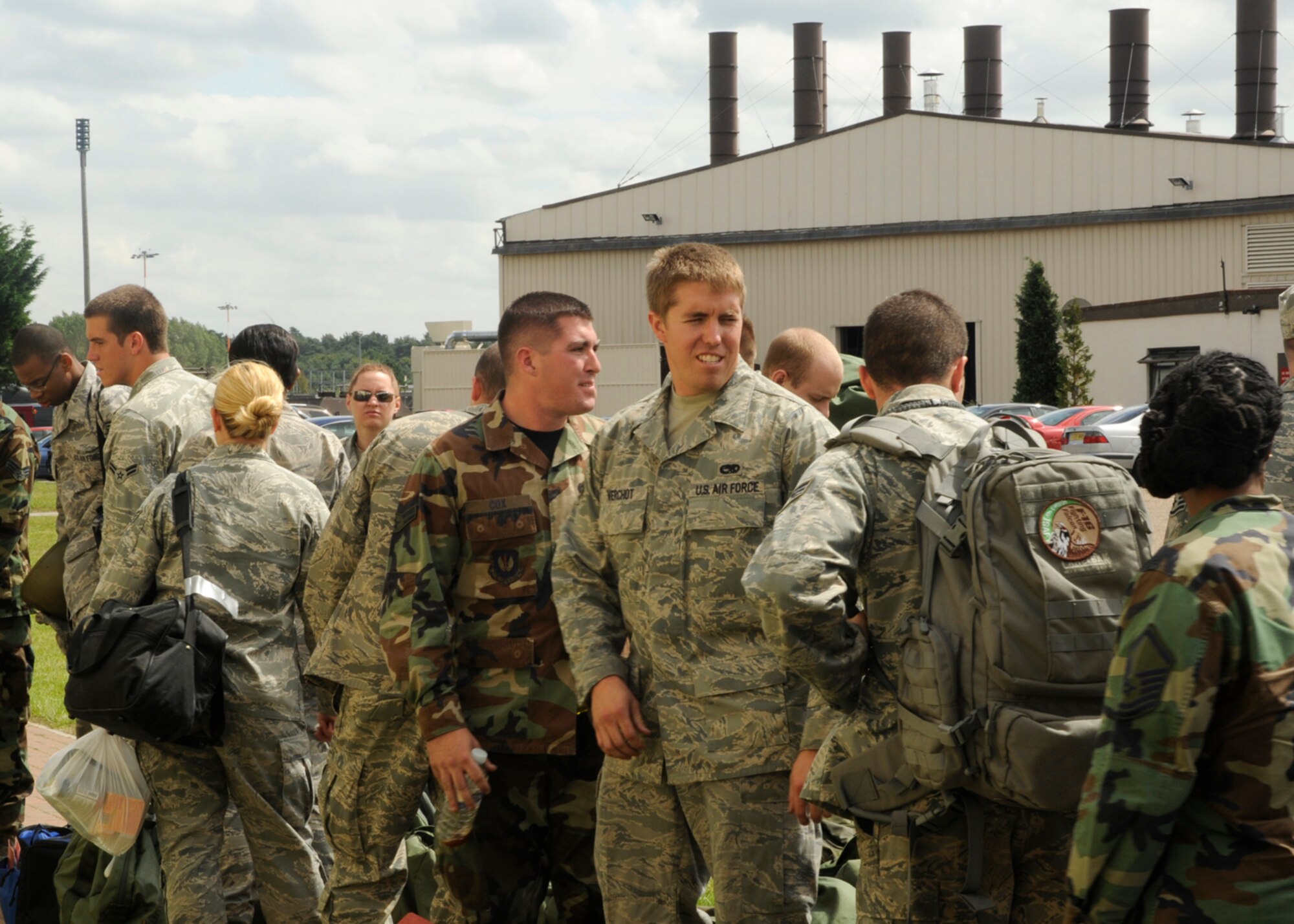 Airmen from various squadrons stand in a processing line waiting for further instructions about their mock pre-deployment tasks July 22, 2009 at RAF Lakenheath, England. This exercise was implemented to prepare the Airmen for real-world deployment. (U.S. Air Force photo/Airman 1st Class Eboni Knox)