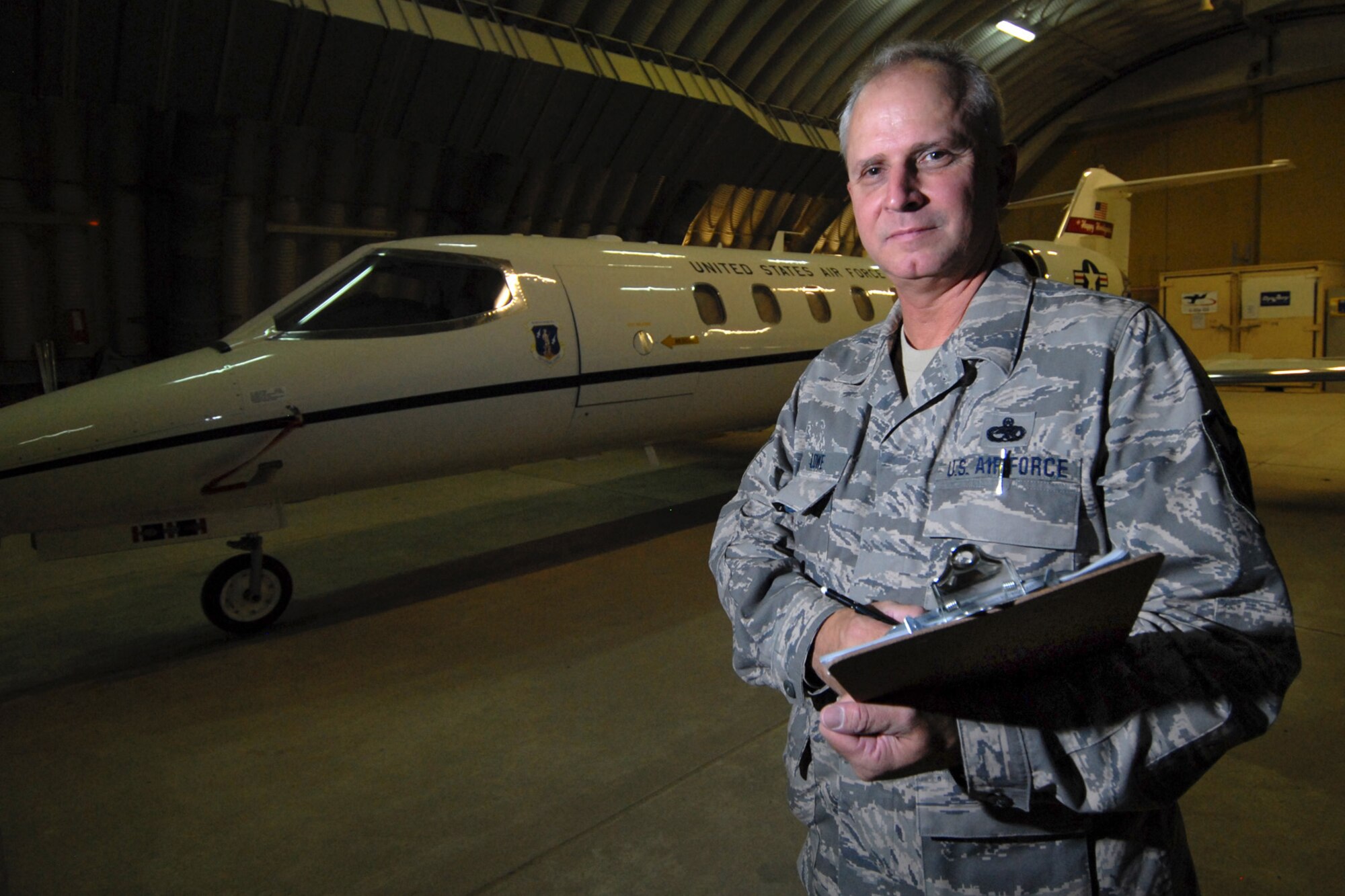Master Sgt. Clinton Lowe, 379th Expeditionary Maintenance Group quality assurance inspector, completes an inspection on a C-21A here, July 29. Sergeant Lowe inspects maintenance processes, at all levels, and serves daily as a technical advisor to the maintenance leadership. He is a native of Fargo, N.D., and is deployed from Hector International Airport, North Dakota Air National Guard, in support of Operations Iraqi and Enduring Freedom.  (U.S. Air Force Photo/Tech. Sgt. Jason W. Edwards)