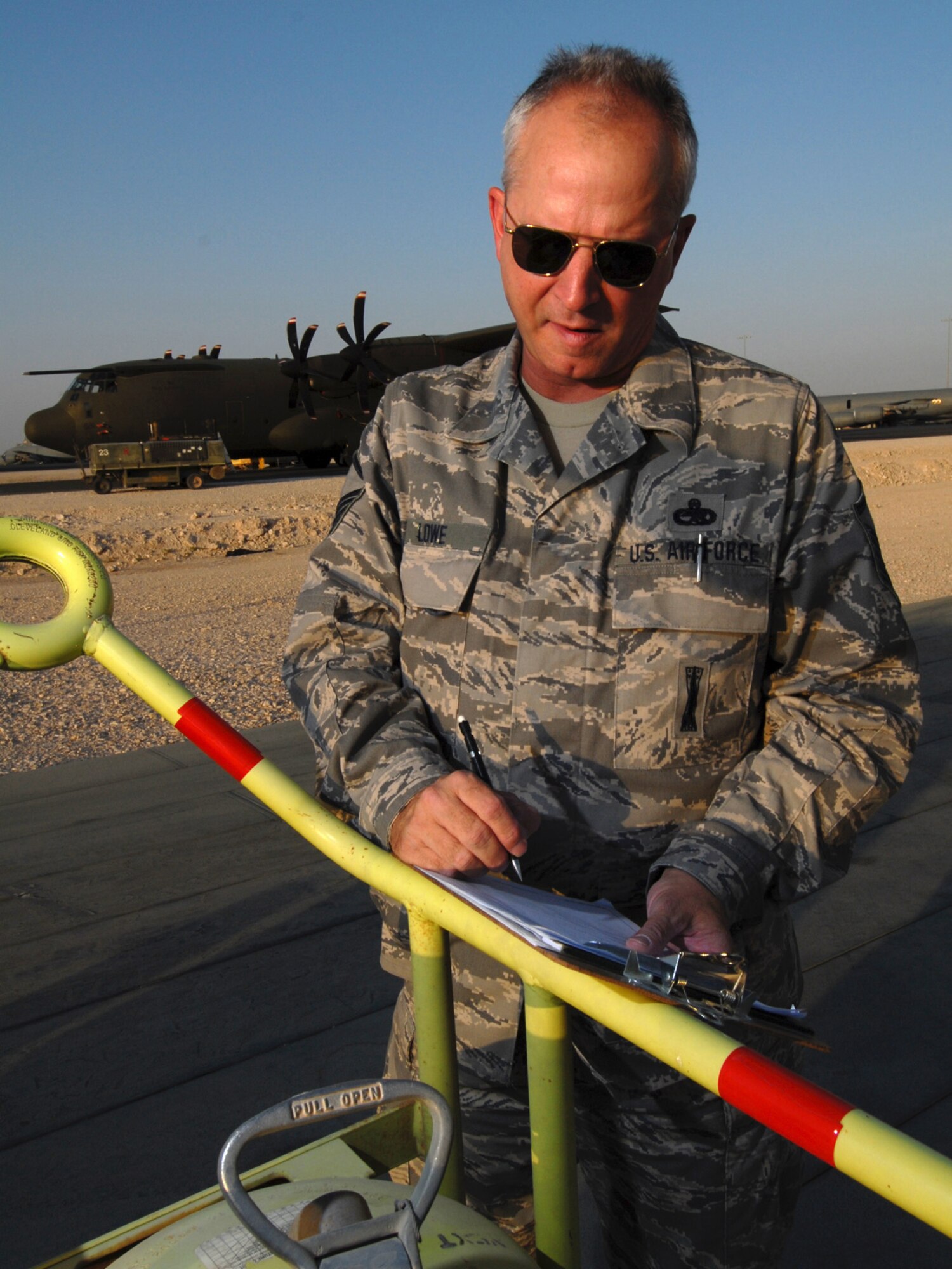 Master Sgt. Clinton Lowe, 379th Expeditionary Maintenance Group quality assurance inspector, inspects a flightline halon fire extinguisher here, July 29. Sergeant Lowe inspects maintenance processes, at all levels, and serves daily as a technical advisor to the maintenance leadership. He is a native of Fargo, N.D., and is deployed from Hector International Airport, North Dakota Air National Guard, in support of Operations Iraqi and Enduring Freedom.  (U.S. Air Force Photo/Tech. Sgt. Jason W. Edwards)