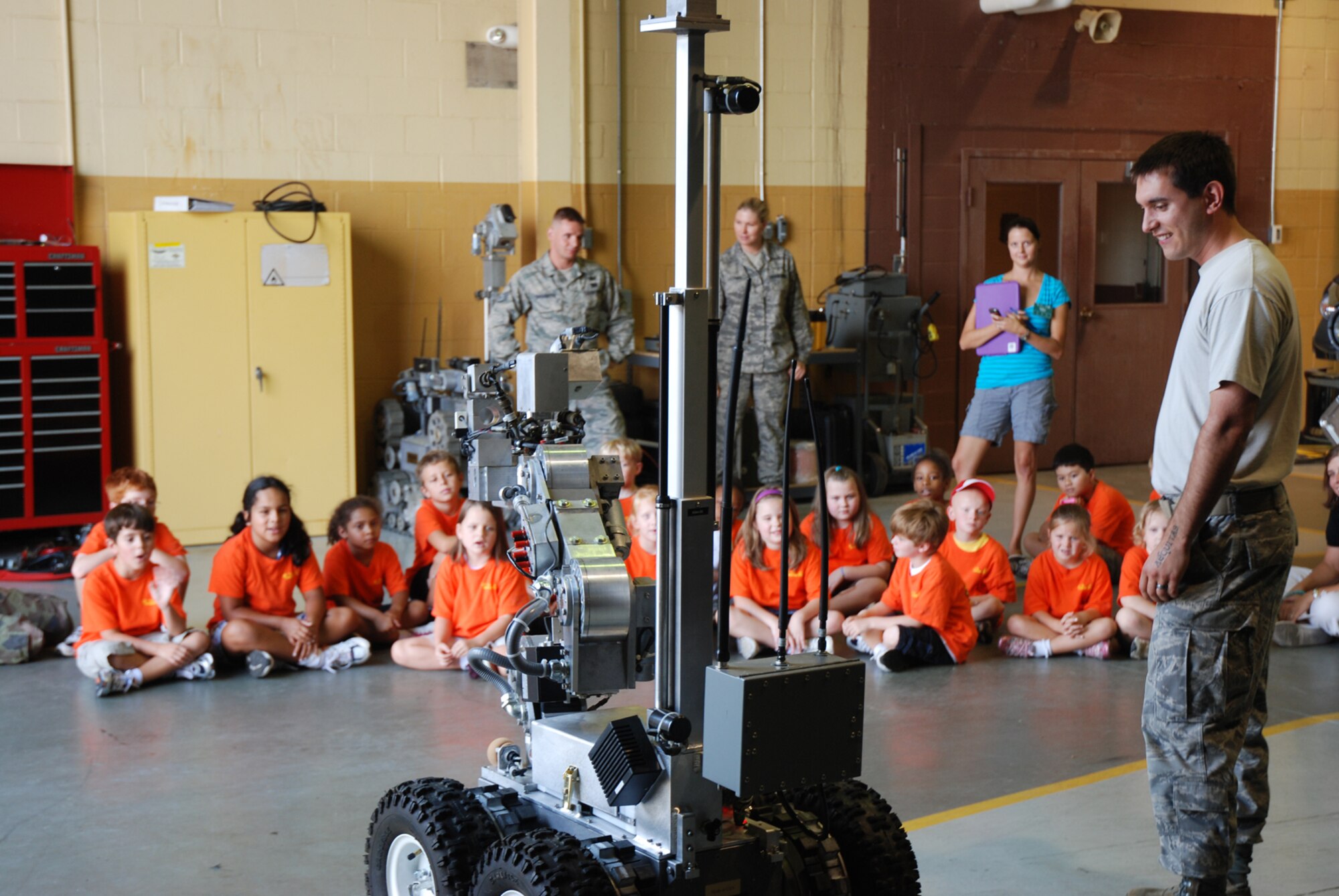 Members of the 94th Explosive Ordnance Disposal Flight show Sunshine House Summer Camp children how their robot works July 28. (U.S. Air Force Photo/Senior Airman Quadoah Ford)