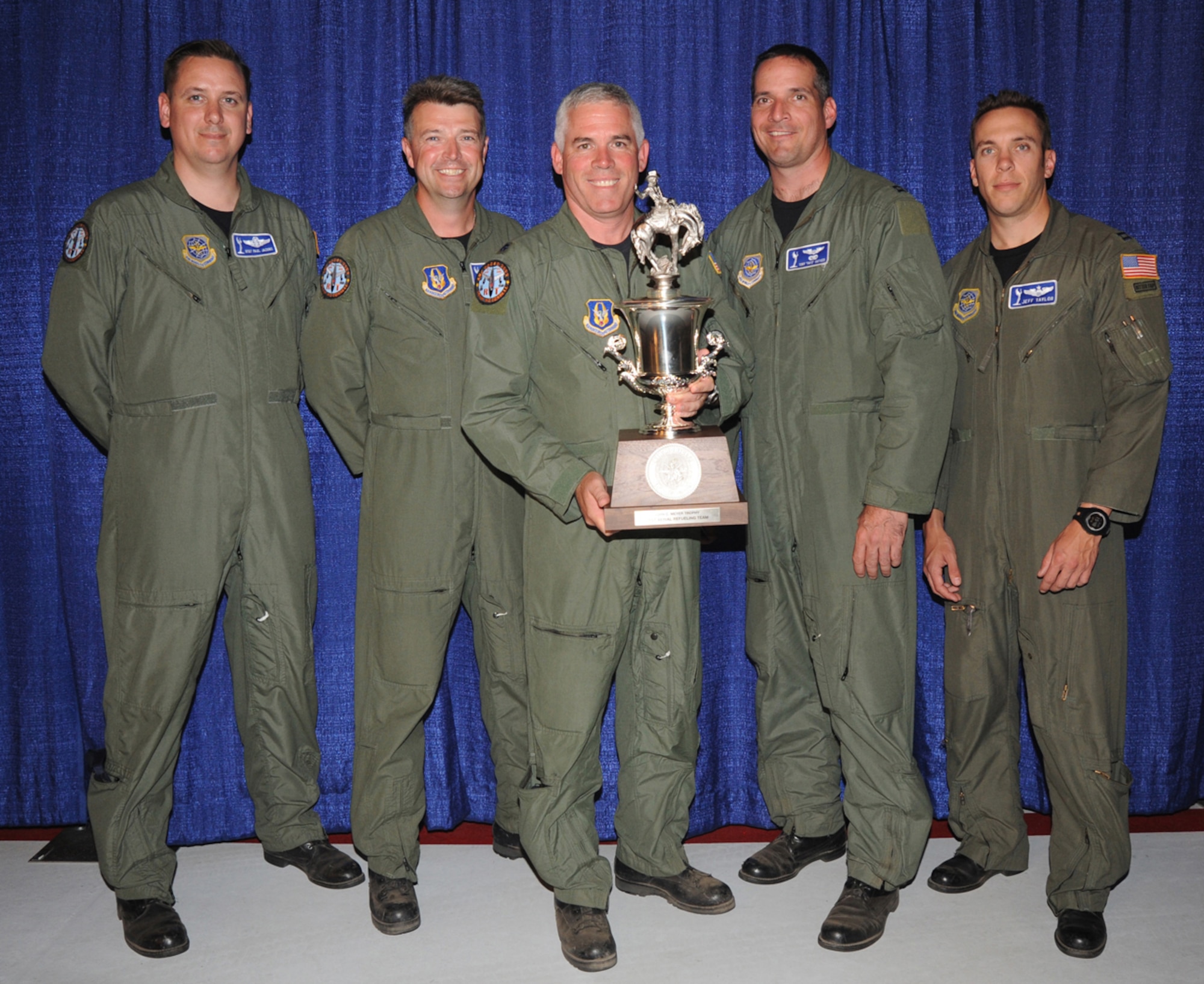 Lt. Col. John Wood, a KC-135 Stratotanker pilot, holds the trophy for Best Aerial Refueling Team at Air Mobility Rodeo 2009 following an awards ceremony at McChord Air Force Base, Wash., July 24, 2009. Colonel Wood and KC-135 boom operator Senior Master Sgt. John Wallman, to Colonel Wood's right, are Air Force reservists in the 931st Air Refueling Group at McConnell AFB, Kan. They teamed up with Regular Air Force Airmen from McConnell's 22nd Air Refueling Wing to win the team award. (U.S. Air Force photo/Tech. Sgt. Chyrece Campbell)

