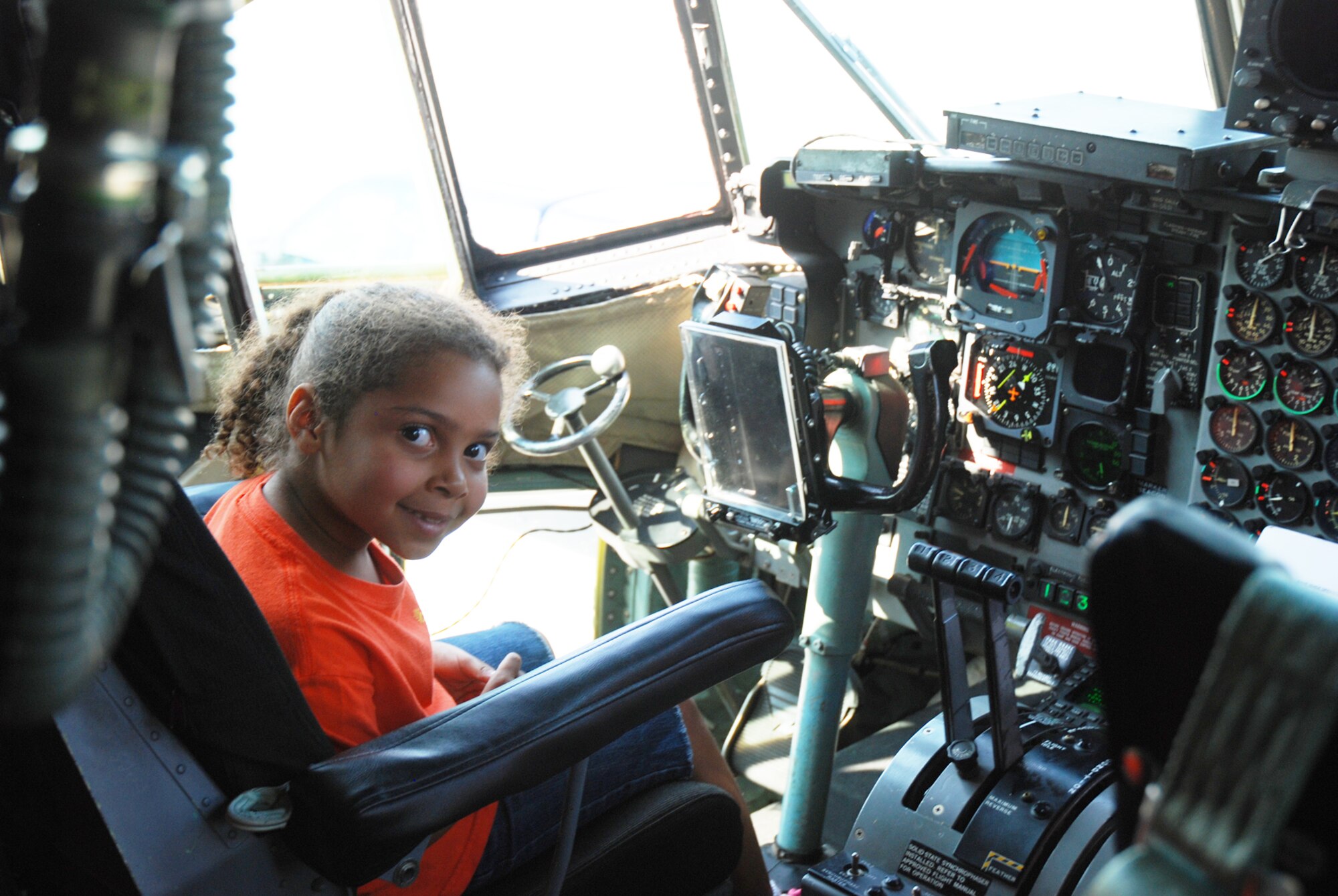 A child with the Sunshine House Summer Camp checks out the cockpit of a C-130 aircraft during a tour July 28. (U.S. Air Force Photo/Senior Airman Quadoah Ford)