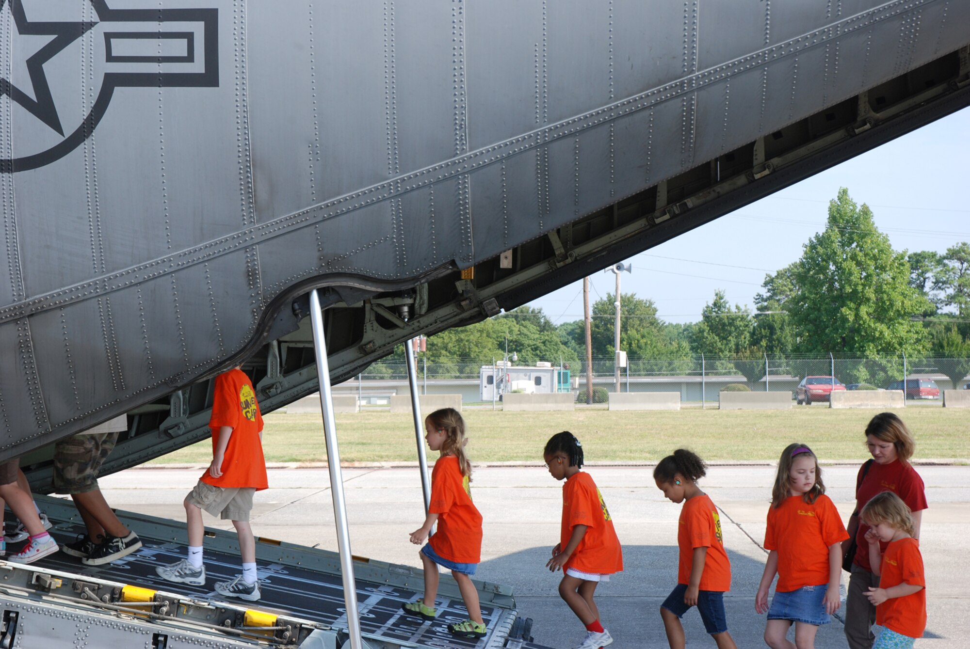 Sunshine House Summer Camp kids walk into a C-130 Hercules with their chaprones during a tour July 28. (U.S. Air Force Photo/Senior Airman Quadoah Ford)