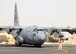 A C-130 Hercules is marshaled into position at the 386th Air Expeditionary Wing parking ramp at an undisclosed location in Southwest Asia July 18, 2009.  The aircraft is assigned to the 777th Expeditionary Airlift Squadron, Joint Base Balad, Iraq and is deployed from the 189th Airlift Wing, Little Rock Air Force Base, Ark.  (U.S. Air Force Photo/Tech Sgt. Tony Tolley)