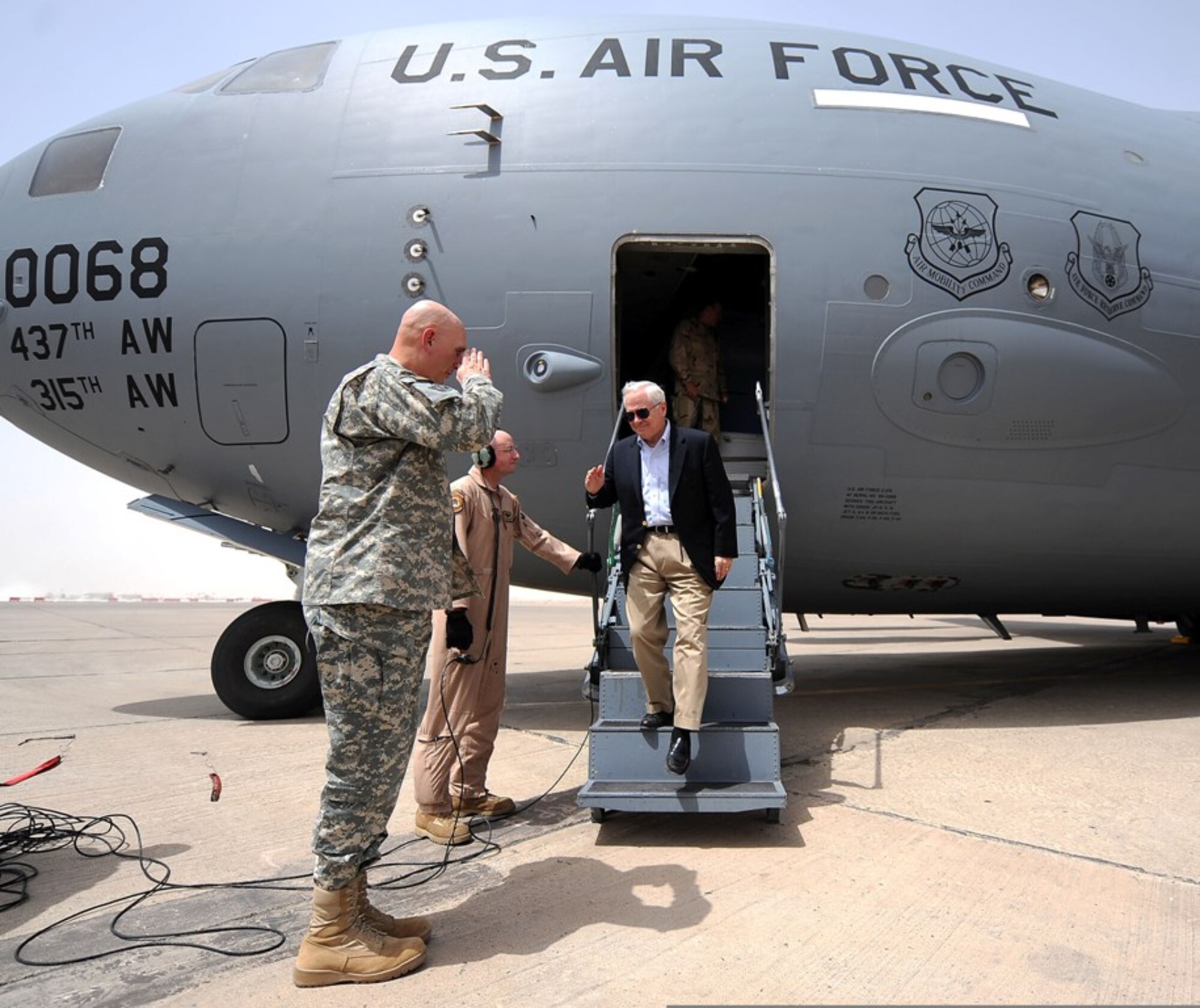 U.S. Secretary of Defense Robert M. Gates steps off of a C-17 Globemaster III from the 437th Airlift Wing at Charleston Air Force Base, S.C., during a trip to Iraq July 28, 2009.  He is greeted by Army Gen. Raymond T. Odierno, commander, Multinational Force - Iraq. Secretary Gates is visiting Iraq to receive operational updates and meet with key Iraqi officials. (U.S. Air Force Photo/Master Sgt. Jerry Morrison)

