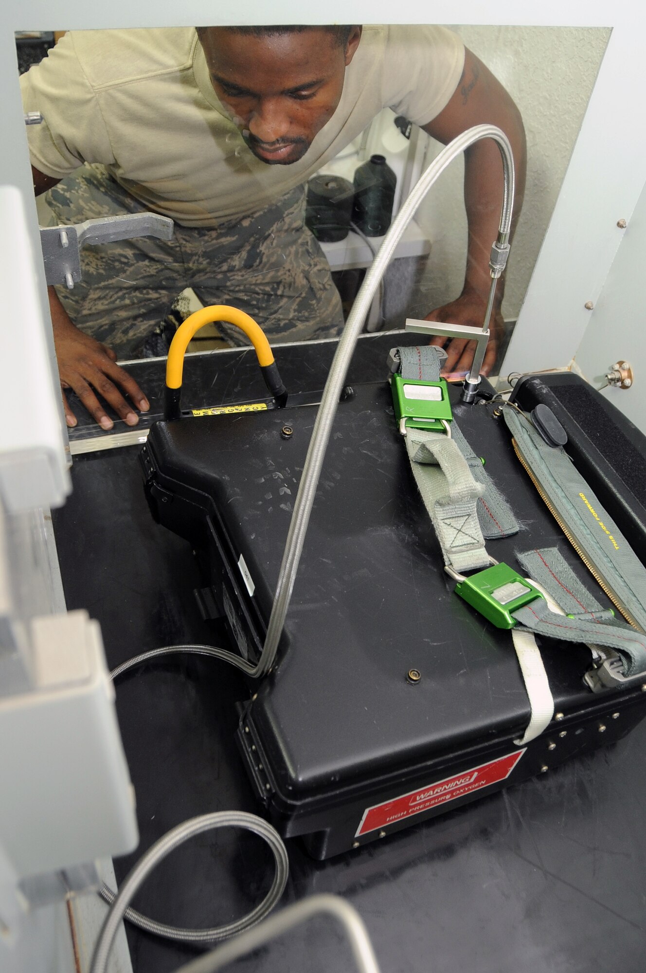 SOUTHWEST ASIA - Staff Sergeant Michael Richardson, 99th Expeditionary Reconnaissance Squadron, physiological support technician, monitors pressure indications while charging equipment up to 2000 pounds per square inch July 29. Sergeant Richardson maintains life support equipment for the pilots of the 99th ERS. (U.S. Air Force photo Tech. Sgt. Charles Larkin Sr.)
