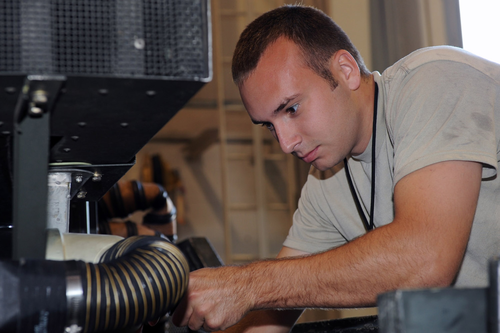 WHITEMAN AIR FORCE BASE, Mo. - Senior Airman Christopher Dewitt, 509th Maintenance Squadron Aerospace Ground Equipment Journeyman, performs maintenance on a Dash-98, which provides high pressure air to the plan to start the engines. AGE mechanics perform anywhere between 40 to 60 hours of maintenance a week in support of the B-2 mission. (U.S. Air Force photo/ Senior Airman Jason Huddleston)