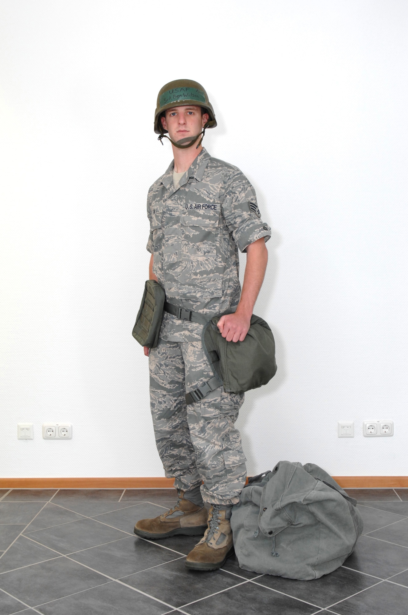 SPANGDAHLEM AIR BASE, Germany -- Senior Airman Benjamin Wilson, 52nd Fighter Wing Public Affairs Office, dresses in Mission Oriented Protective Posture 0.  People need to wear their individual protective equipment in MOPP 0 and carry their protective mask.  Field gear is worn as directed.  Aircrew will carry their protective mask. (U.S. Air Force photo by Master Sgt. Bill Gomez)