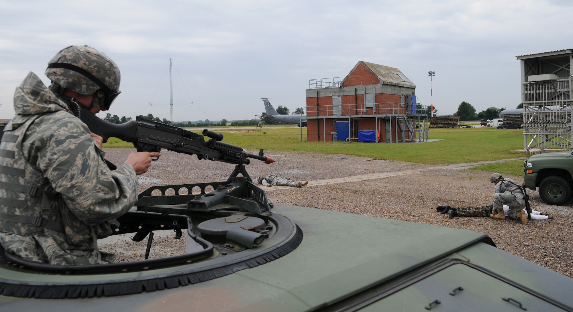 RAF MILDENHALL, England – Airman 1st Class Tate Kaspar, of the 100th Security Forces Squadron, provides overwatch while Senior Airman Michael Kennedy, of the 100th SFS, searches a suspect who attempted to infiltrate the Base X perimeter July 21. A Phase II exercise was conducted here July 20-22 south of the flightline in preparation for an upcoming Operational Readiness Inspection. (U.S. Air Force photo by Senior Airman Thomas Trower)