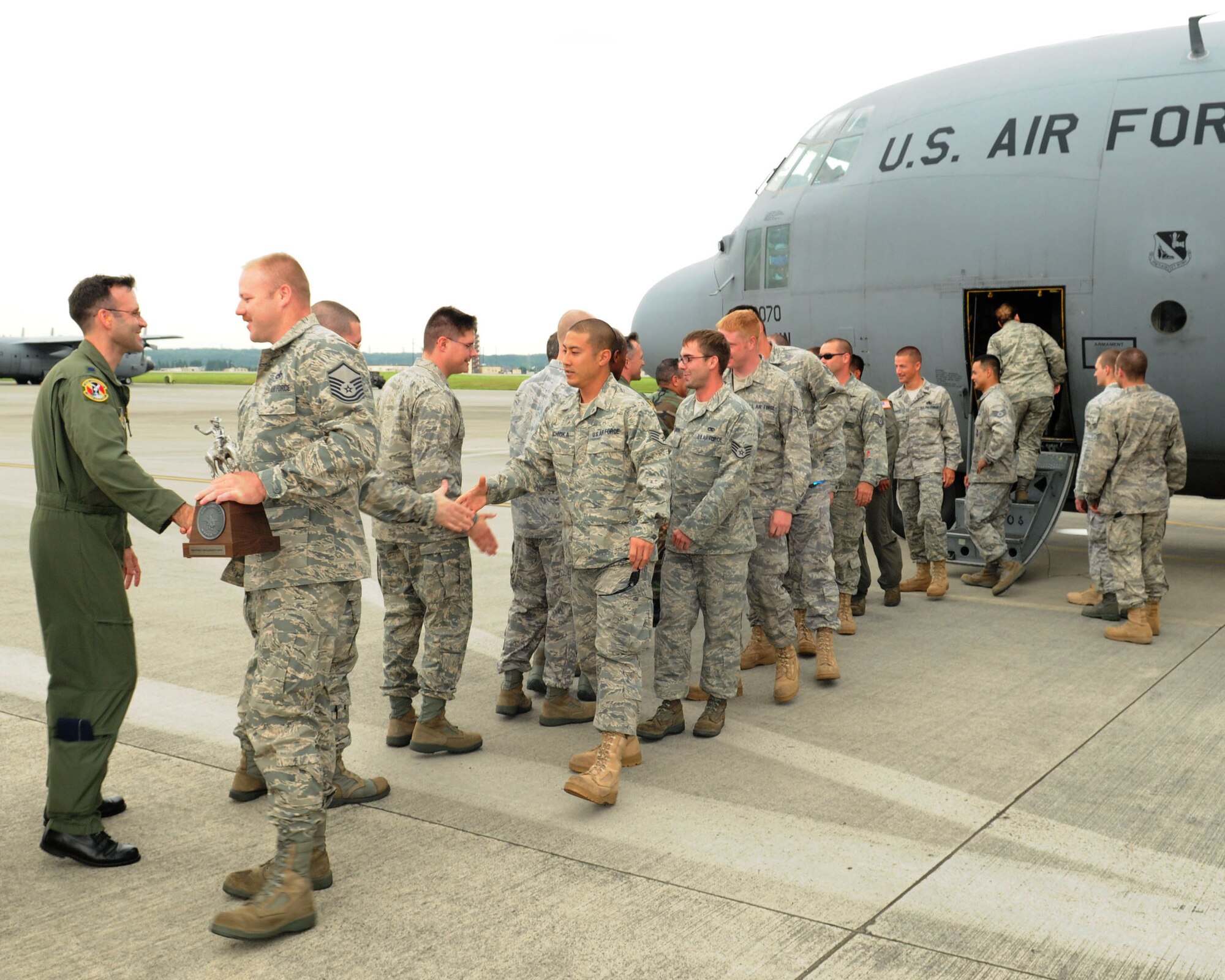 YOKOTA AIR BASE, Japan -- Members of the Yokota maintenance team who brought home the Knuckle Buster Award from the 2009 Air Mobility Command Rodeo receive a warm welcome back from the 374th Airlift Wing leadership July 28. The award recognized the maintenance team that displayed the highest professionalism, dedication and mutual respect for their competitors. (U.S. Air Force photo/Airman 1st Class Sean Martin)