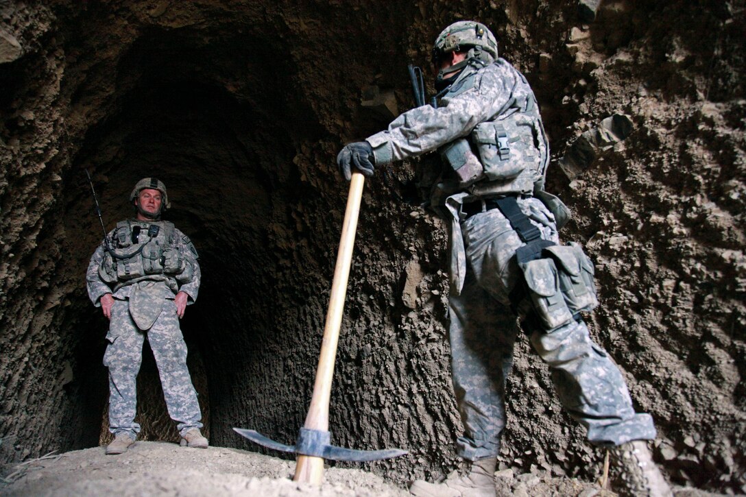U.S. Army Spc. Jonathan Araiza, right, rests after searching a cave for enemy weapons caches near Shah Wali Zarat in Khost province, Afghanistan, July 24, 2009. Araiza is assigned to the 25th Infantry Division's Company A, 425th Brigade Special Troops Battalion, 4th Brigade Combat Team.