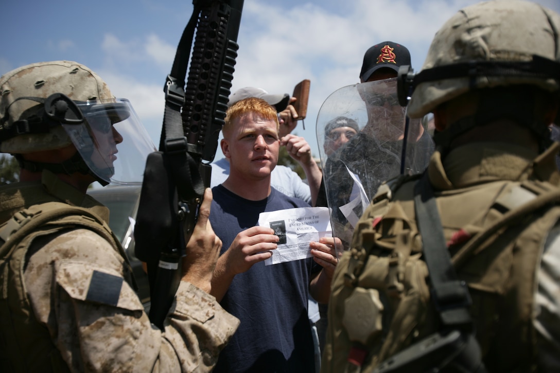 Marines with Battalion Landing Team 2/4 practice riot control tactics during noncombatant evacuation training here July 29 to prepare the Marines for a deployment with the 11th Marine Expeditionary Unit later this year.
