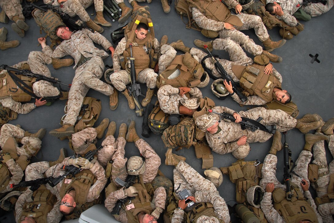 Marines rest on a boat ride from Camp Pendleton, Calif., to the amphibious assault ship USS Bonhomme Richard July 29 after conducting a noncombatant evacuation exercise, part of the 11th Marine Expeditionary Unit’s pre-deployment training.
