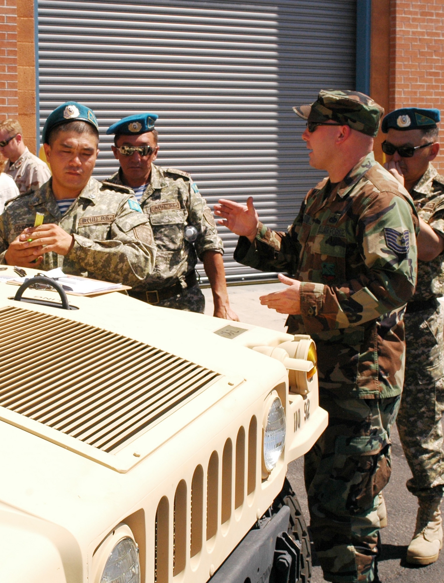 Tech. Sgt. Frank Quinn, 162nd Logistics Readiness Squadron, shows officers from Kazakhstan’s peacekeeping force how to calculate the center balance of a Humvee for airlift, July 28. The delegation’s visit to the 162nd Fighter Wing at Tucson International Airport was organized through the Arizona National Guard’s state partnership with the Central Asian country. (Air National Guard photo by Capt. Gabe Johnson)