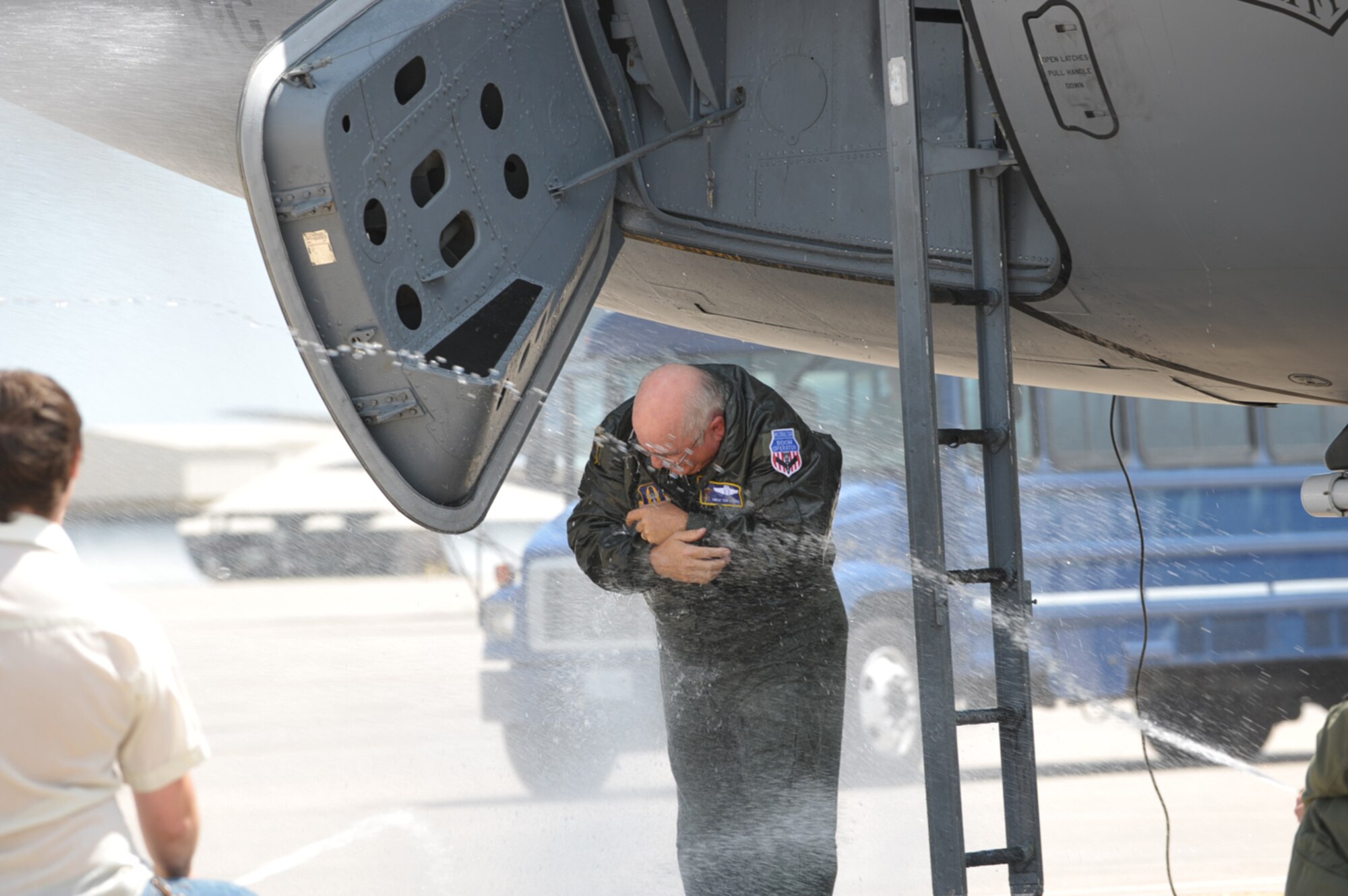 Chief Master Sgt. Don Askren receives a wet welcome after his final KC-135 Stratotanker mission was completed at McConnell Air Force Base, Kan., on July 30. He is scheduled to soon retire as the chief boom operator of the 18th Air Refueling Squadron, the flying unit of the 931st Air Refueling Group. Wet downs are a tradition for flyers when they finish their final flight. (U.S. Air Force photo/Tech. Sgt. Jason Schaap)