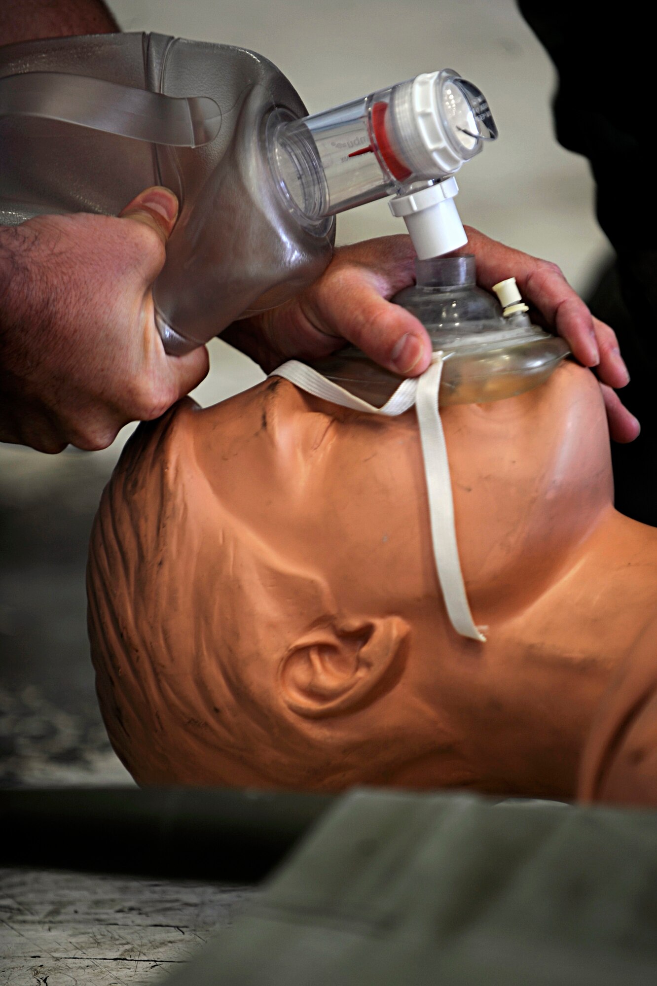Staff Sgt. Chris Huiras, 28th Civil Engineer Squadron fire fighter, simulates reviving an Airman using a resuscitation mask during a fuel tank exercise here, July 30. The exercise simulated the actions Airmen would take in case someone became unconscious in a fuel tank emergency scenario. (U.S. Air Force photo/Airman 1st Class Matthew Flynn)