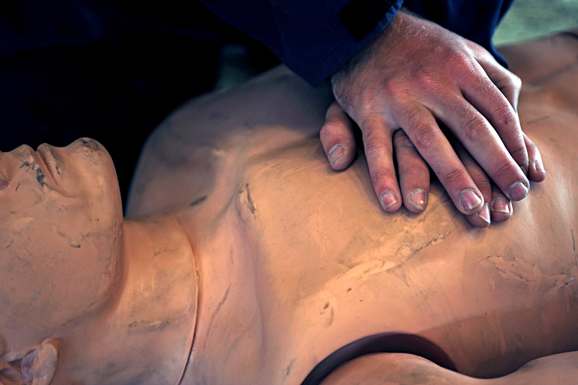 Airman 1st Class Dustin Roy, 28th Maintenance Squadron aircraft fuel systems repair apprentice, performs chest compressions on a dummy during a fuel tank extraction exercise here, July 30. During the exercise, Airman Roy and another Airman took turns performing cardiopulmonary resuscitation until emergency response units arrived.  (U.S. Air Force photo/Airman 1st Class Matthew Flynn)