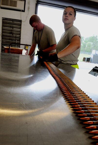 MOODY AIR FORCE BASE, Ga. – Senior Airmen Patrick Lang and Erin Sheppard, 23rd Equipment Maintenance Squadron munitions flight conventional munitions crewmembers, transport .50 caliber bullets here July 15. The .50 caliber bullets are used for the machine guns attached to the HH-60G Pave Hawk. (U.S. Air Force photo by Airman 1st Class Joshua Green)