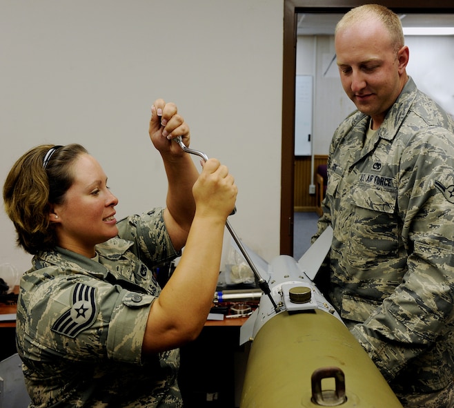 MOODY AIR FORCE BASE, Ga. -- Staff Sgt. Rebecca Montelius, 23rd Equipment Maintenance Squadron conventional munitions crew chief, and Airman Andrew Frye, 23rd EMS munitions system apprentice, attach a guidance and control section to the back of a missile during training here July 15. (U.S. Air Force photo by Airman 1st Class Joshua Green)