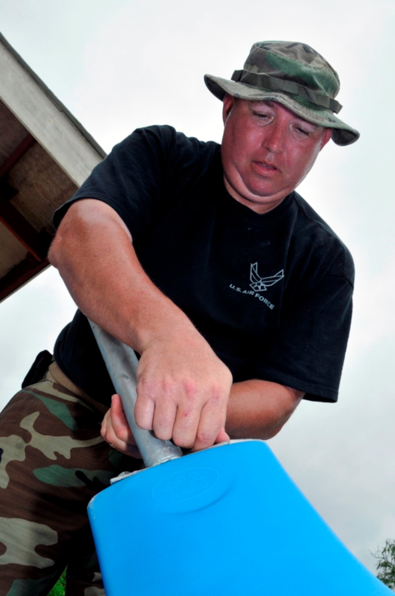 U.S. Air Force Senior Master Sgt. Robert Gilligan, a heavy equipment superintendent with the 301st Civil Engineer Squadron (CES), Naval Air Station Joint Reserve Base Fort Worth, Texas, builds a slide for a new playground in Georgetown, Guyana, July 10, 2009. Airmen from the 301st CES deployed to Guyana for two weeks to renovate the Timehri Primary School and install two playgrounds for the children. (U.S. Air Force photo by Airman 1st Class Perry Aston/Released)