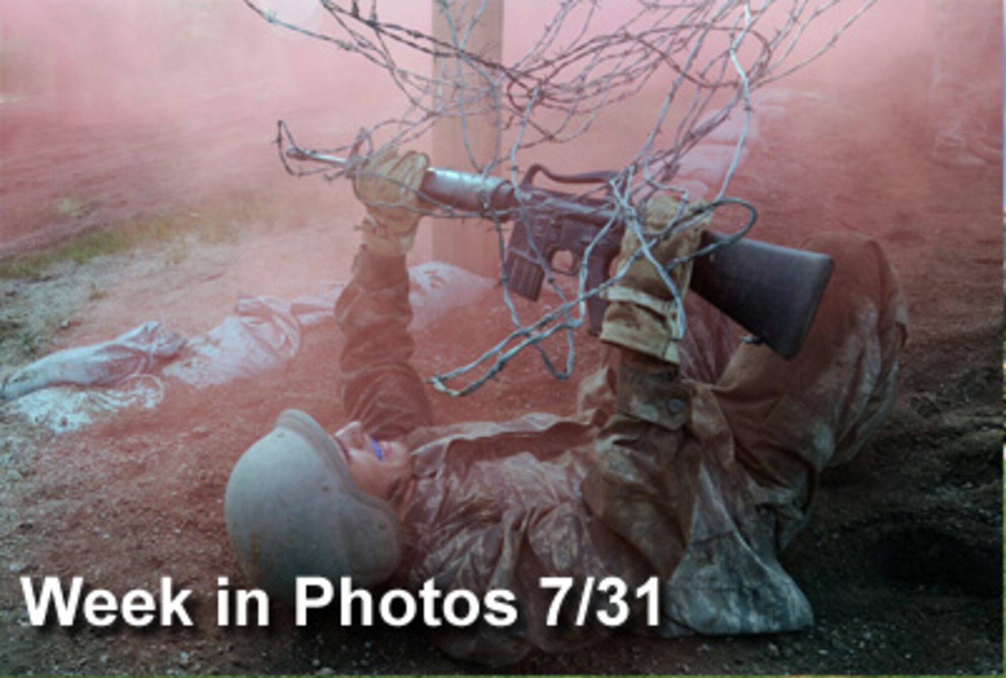 Air Force Week in Photos for July 31 highlights photos from around the Air Force. In this photo by Mike Kaplan, Air Force Academy Basic Cadet Evan Rowley inches his way  under barbed wire in the Jacks Valley Assault Course July 21 near Colorado Springs, Colo.  (U.S. Air Force illustration) 

