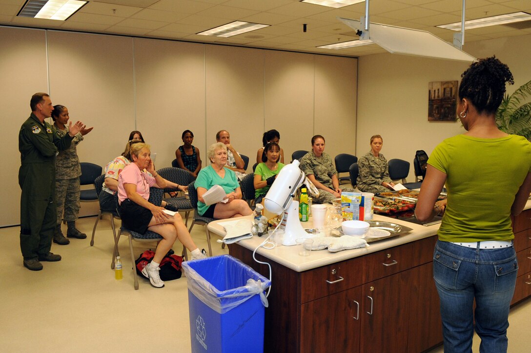 BUCKLEY AIR FORCE BASE, Colo. – Col. Clinton Crosier, 460th Space Wing commander, and 460th SW Command Chief Master Sgt. Arleen Heath observe Sandy Jefferson during a Healthy Heart Cooking Demonstration class at the Buckley Health and Wellness Center July 17. The Healthy Heart Cooking Demonstration is held every month on the third Friday. For more information contact the HAWC at 720-847-6414. (U.S. Air Force photo by Senior Airman John Easterling)
