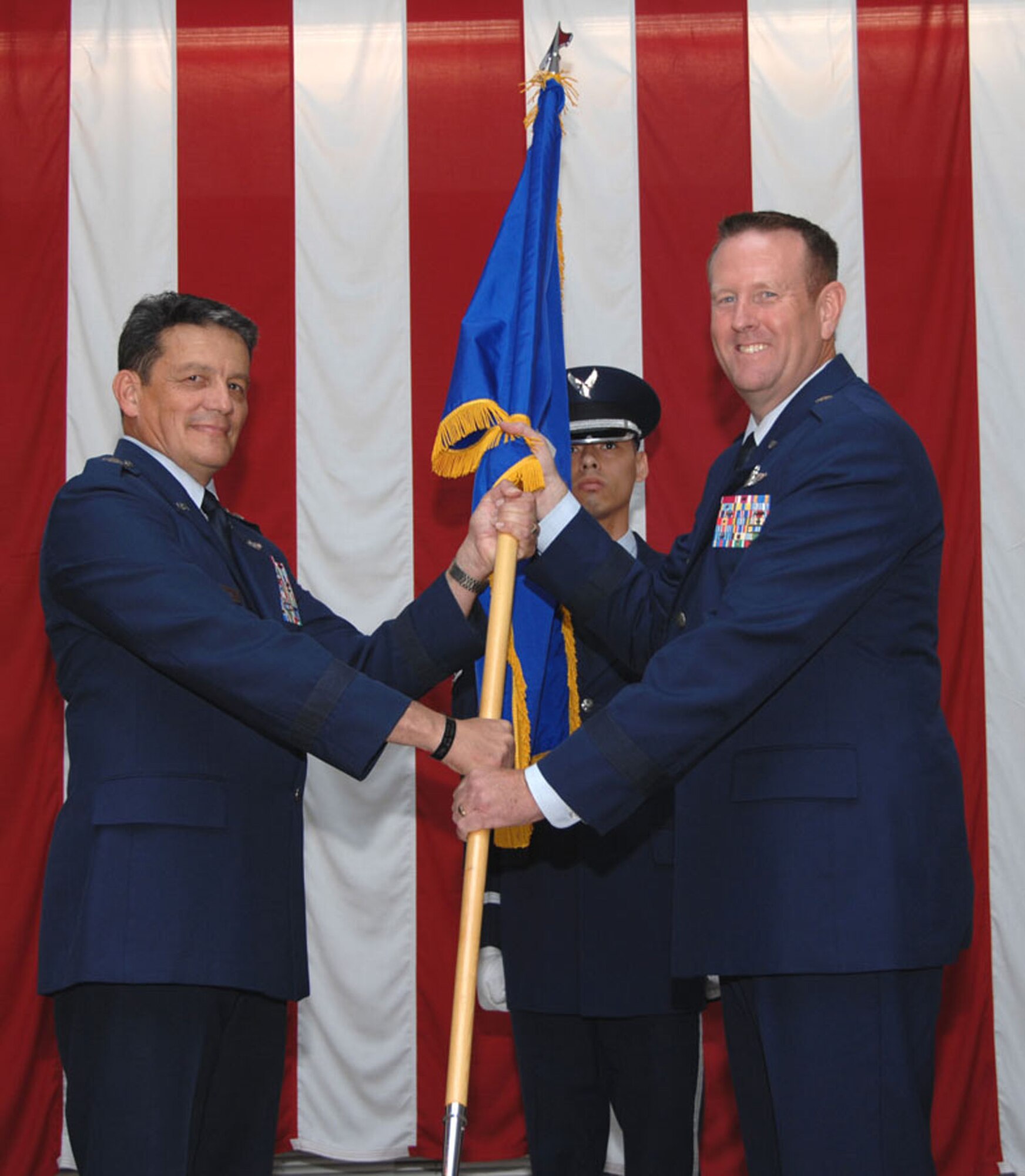 TRAVIS AIR FORCE BASE, Calif. -- Maj. Gen. Frank Padilla presents the general officer flag to newly promoted Brig. Gen. Robert Millmann. Both Gen’s Padilla and Millmann were previously assigned to Travis. Maj Gen Frank Padilla was previously the 312th AS commander here and Gen Millmann was both the previous 79th ARS commander and the 349th AMW vice commander. (U.S. Air Force photo/Master Sgt. Robert Wade)
