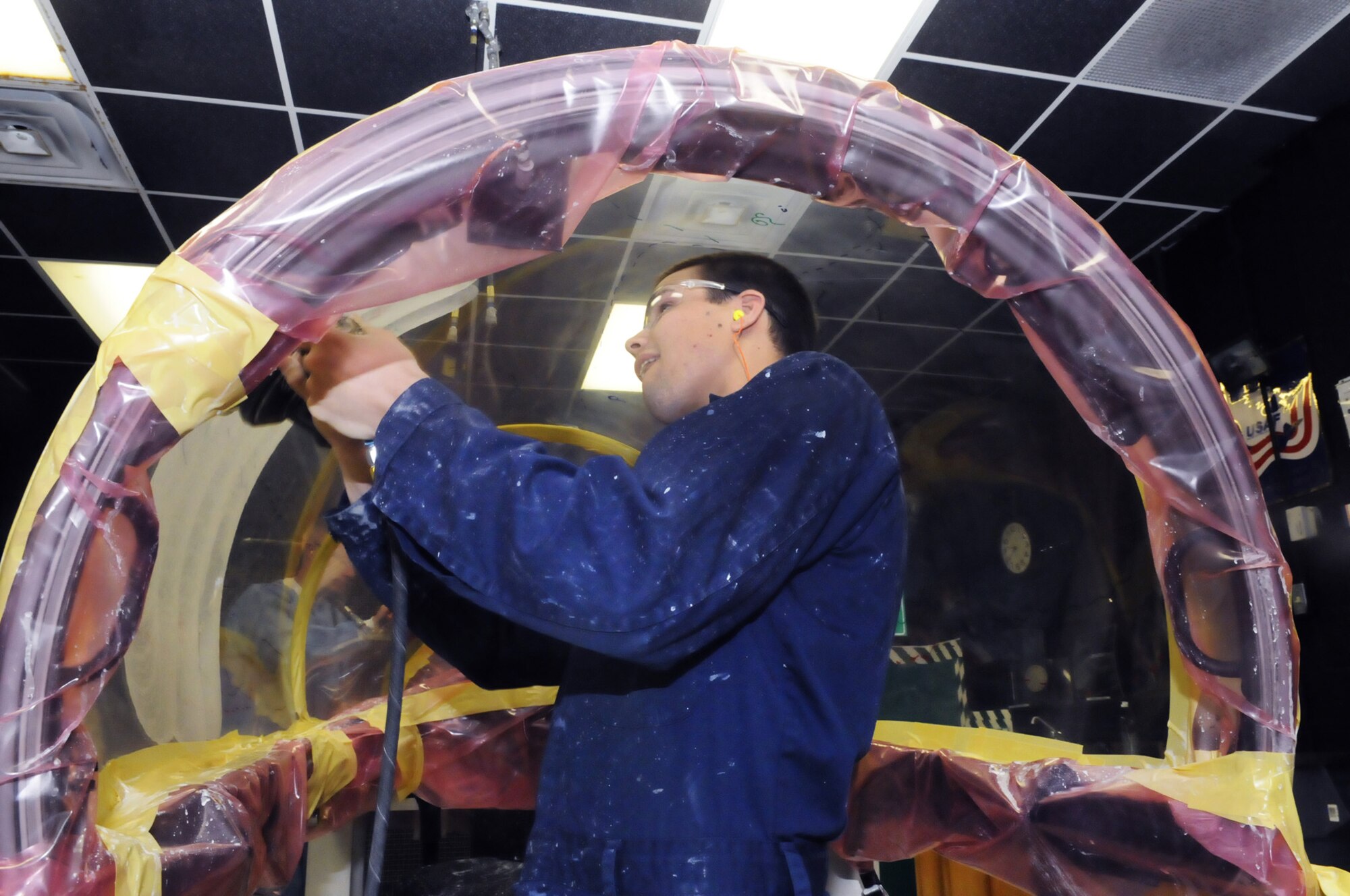 SSgt. Roy Nunn, Oregon Air National Guard, polishes the inside of an F-15 canopy. Sgt. Nunn has been training in the canopy shop here at Robins for the last 2 weeks. U. S. Air Force photo by Sue Sapp