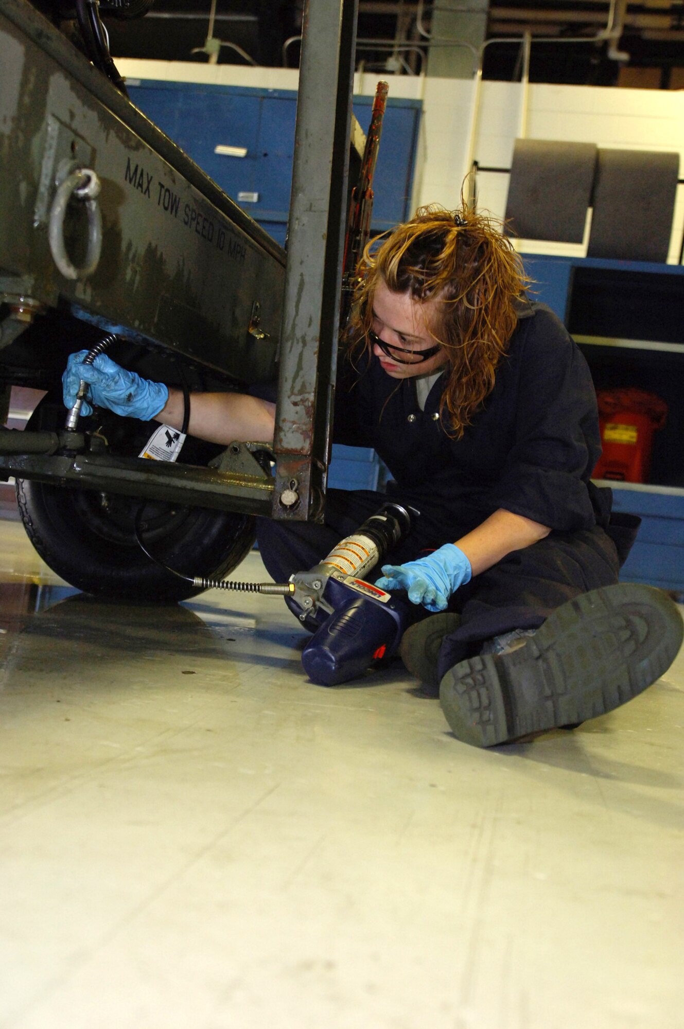 Airman 1st Class Jodi Ebnit prepares to fill the oil on a dash 95 large air start system July 27 at Minot Air Force Base, N.D. The 5th Maintenance Squadron Aerospace Ground Equipment Flight recently initiated an Air Force Smart Operations for the 21st century process to increase the unit's efficiency to meet the base's mission. Airman Ebnit is an AGE technician. (U.S. Air Force photo/Tech. Sgt. Lee A. Osberry Jr.) 