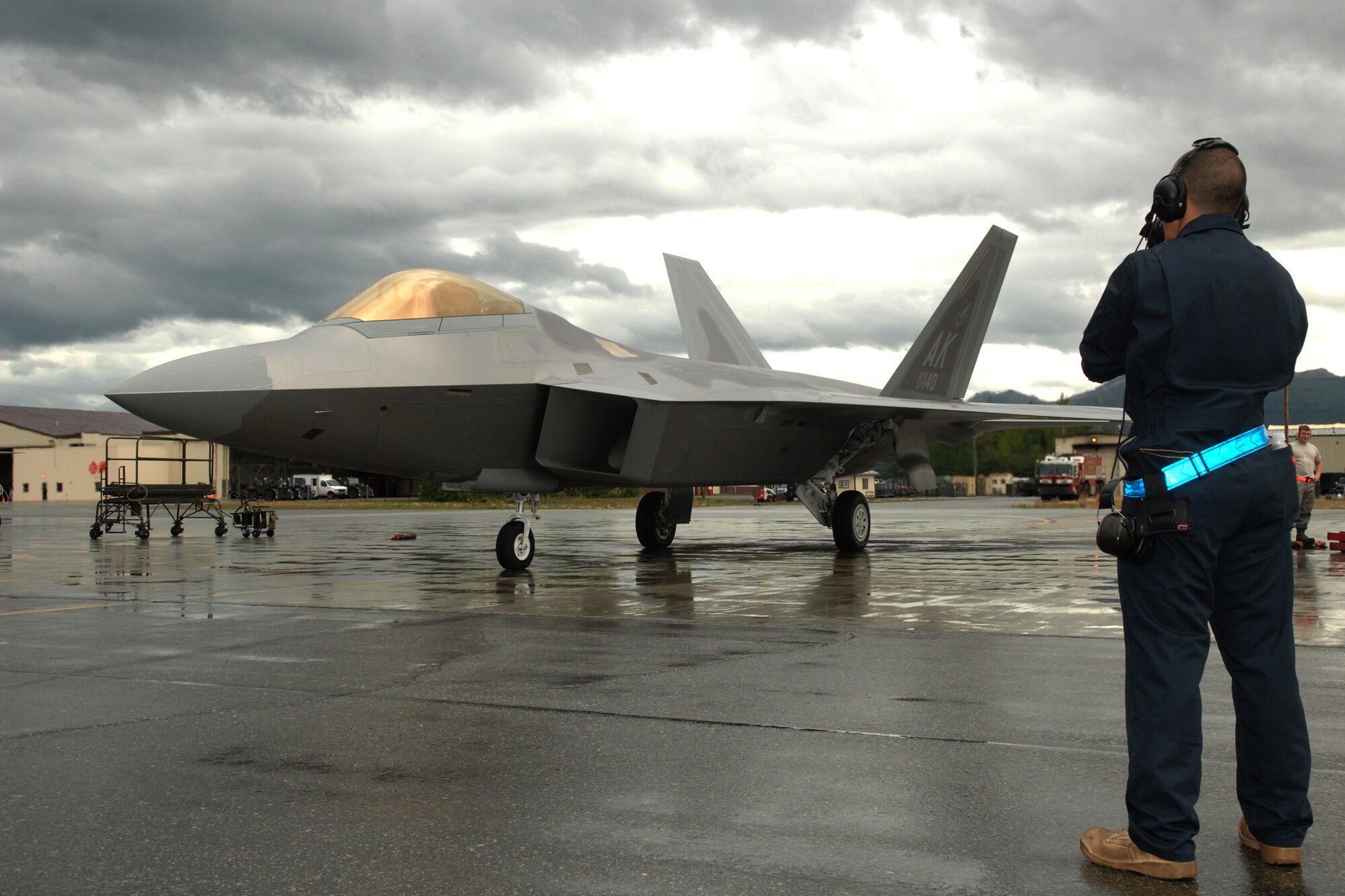 ELMENDORF AIR FORCE BASE, Alaska -- Airman 1st Class Adam Seager, 90th Aircraft Maintenance Unit, stands by as one of Elmendorf's F-22 Raptors prepares for take-off July 29 during Red Flag-Alaska 09-3. Red Flag-Alaska is a Pacific Air Forces directed field training exercise for U.S. forces, flown under simulated air combat conditions. It is conducted on the Joint Pacific Alaskan Range Complex with air operations flown out of Eielson and Elmendorf Air Force bases. (U.S. Air Force photo/Airman 1st Class Christopher Gross)