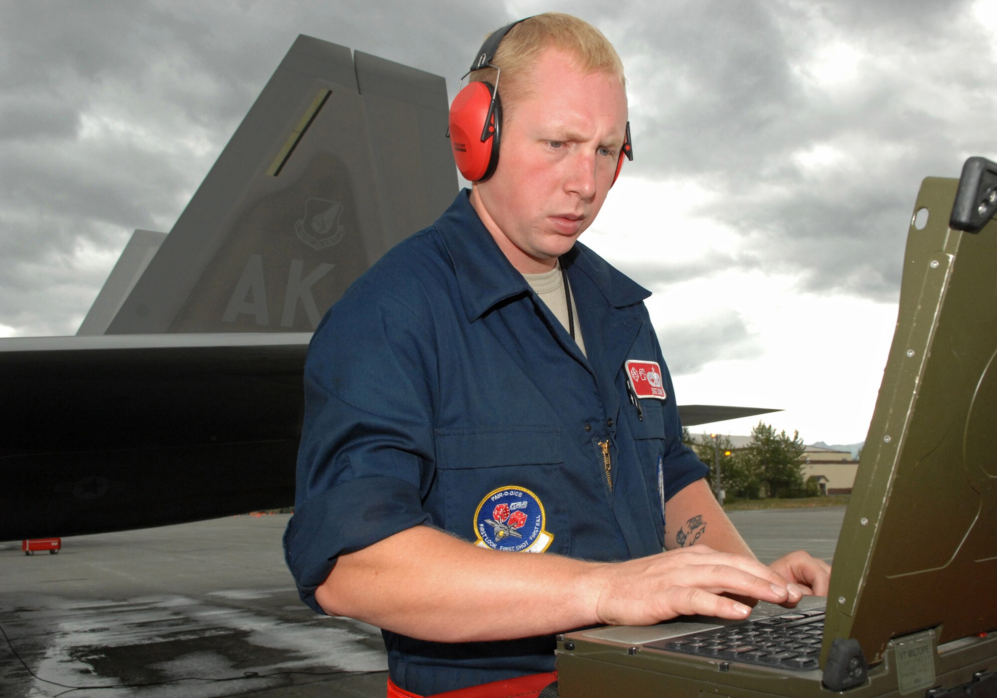 ELMENDORF AIR FORCE BASE, Alaska -- Staff Sgt. Michael Doane, 90th Aircraft Maintenance Unit, helps prepare one of Elmendorf's F-22 Raptors for takeoff July 29 during Red Flag-Alaska 09-3. Red Flag-Alaska is a Pacific Air Forces directed field training exercise for U.S. forces, flown under simulated air combat conditions. It is conducted on the Joint Pacific Alaskan Range Complex with air operations flown out of Eielson and Elmendorf Air Force bases. (U.S. Air Force photo/Airman 1st Class Christopher Gross)