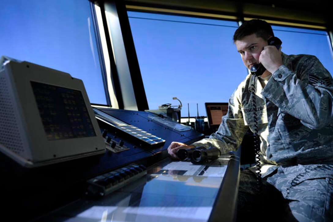 Staff Sgt. Brad Hermosillo, 28th Operations Support Squadron air traffic control specialist, speaks with a radar crew member here, July 28. Air traffic controllers from the control tower relay information to pilots and Airmen in radar approach control. (U.S. Air Force photo by Airman 1st Class Corey Hook)