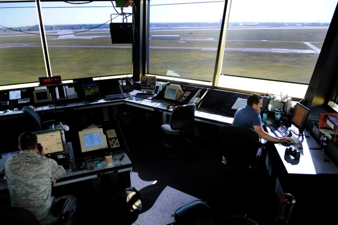 (Left) Mr. Shane Swartwood and Staff Sgt. Brad Hermosillo control and regulate en route and terminal air traffic here, July 28. Mr. Swartwood and Sergeant Hermosillo are both assigned to the 28th Operations Support Squadron as air traffic control specialists. (U.S. Air Force photo by Airman 1st Class Corey Hook)