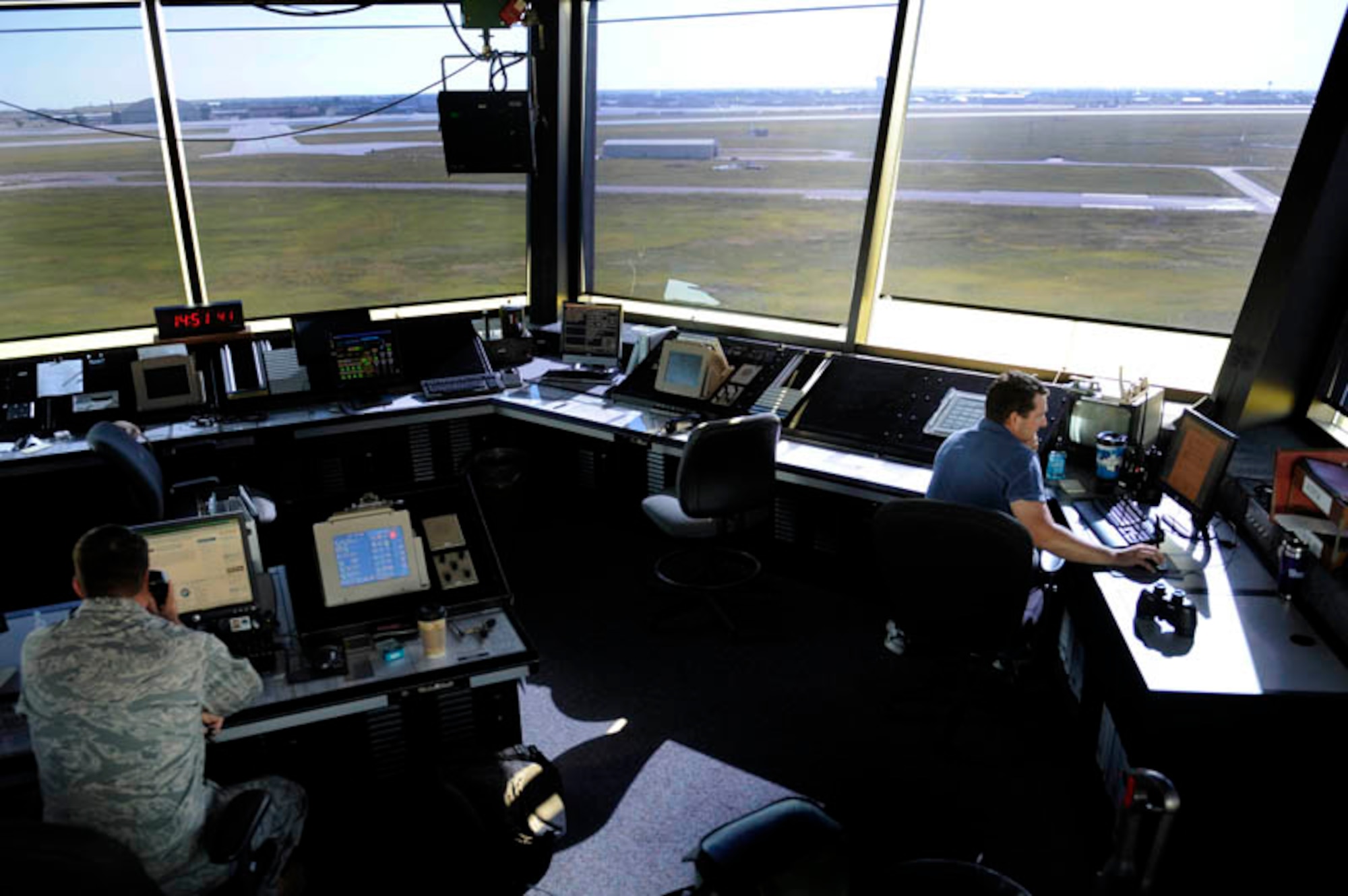 (Left) Mr. Shane Swartwood and Staff Sgt. Brad Hermosillo control and regulate en route and terminal air traffic here, July 28. Mr. Swartwood and Sergeant Hermosillo are both assigned to the 28th Operations Support Squadron as air traffic control specialists. (U.S. Air Force photo by Airman 1st Class Corey Hook)