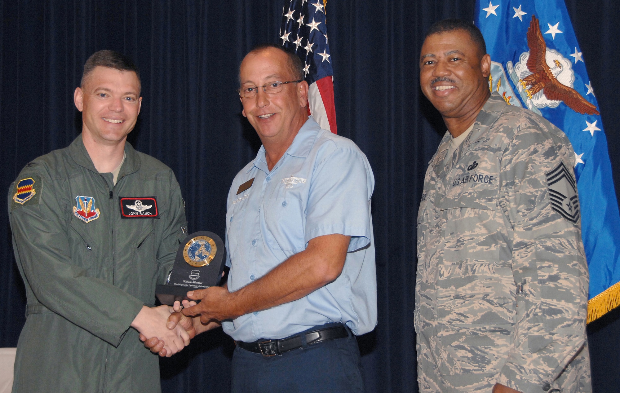 William Allmaker, the lodging facility manager for the 55th Force Support Squadron, receives the Junior Craftsman of the Quarter Award from Colonel John T. Rauch Jr., 55th Wing vice commander,  and Chief Master Sgt. Victor Rountree, 55th Comptroller Squadron and Wing Staff superintendant, at the 55th Wing Quarterly Awards held at the Offutt Patriot Club July 23. U.S. Air Force photo by D.P. Heard