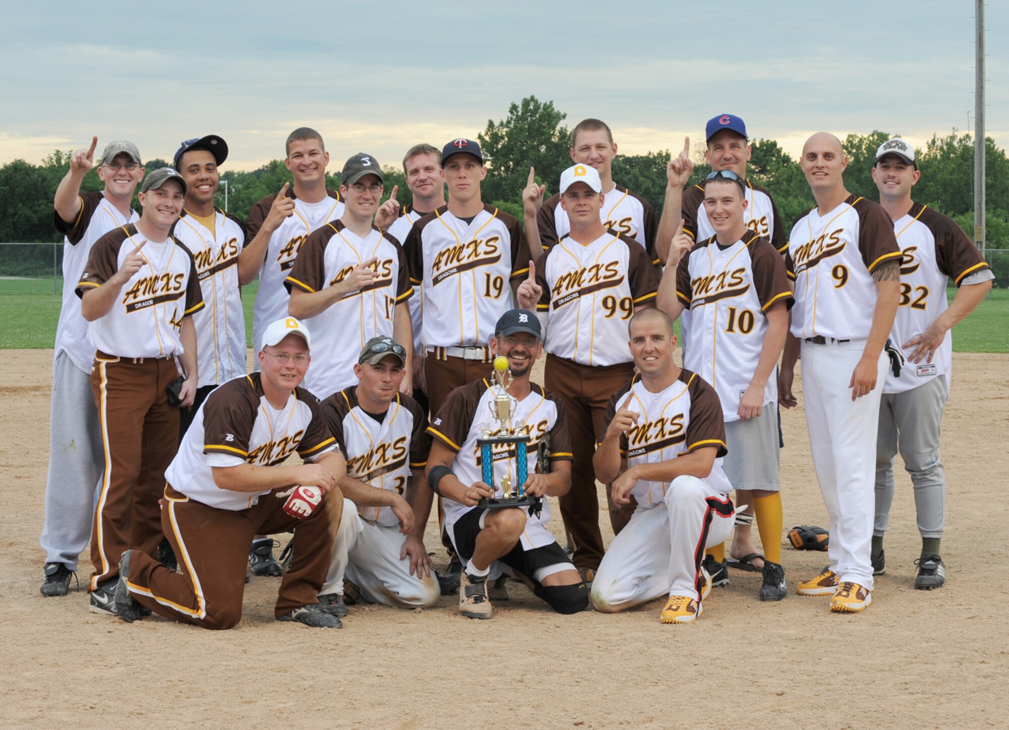 WHITEMAN AIR FORCE BASE, Mo. - Seventeen members of the Aircraft Maintenance Squadron pose with their trophy after beating Security Forces and winning the 2009 Intermural Men's Softball Championship, July 29. The final score of this seven inning game was 21-4, making AMXS two years undefeated and having won 33 straight games. The season consisted of nine regular season games against other whitemanites and three playoff games. (U.S. Air Force Photo by Airman 1st Class Carlin Leslie) 
