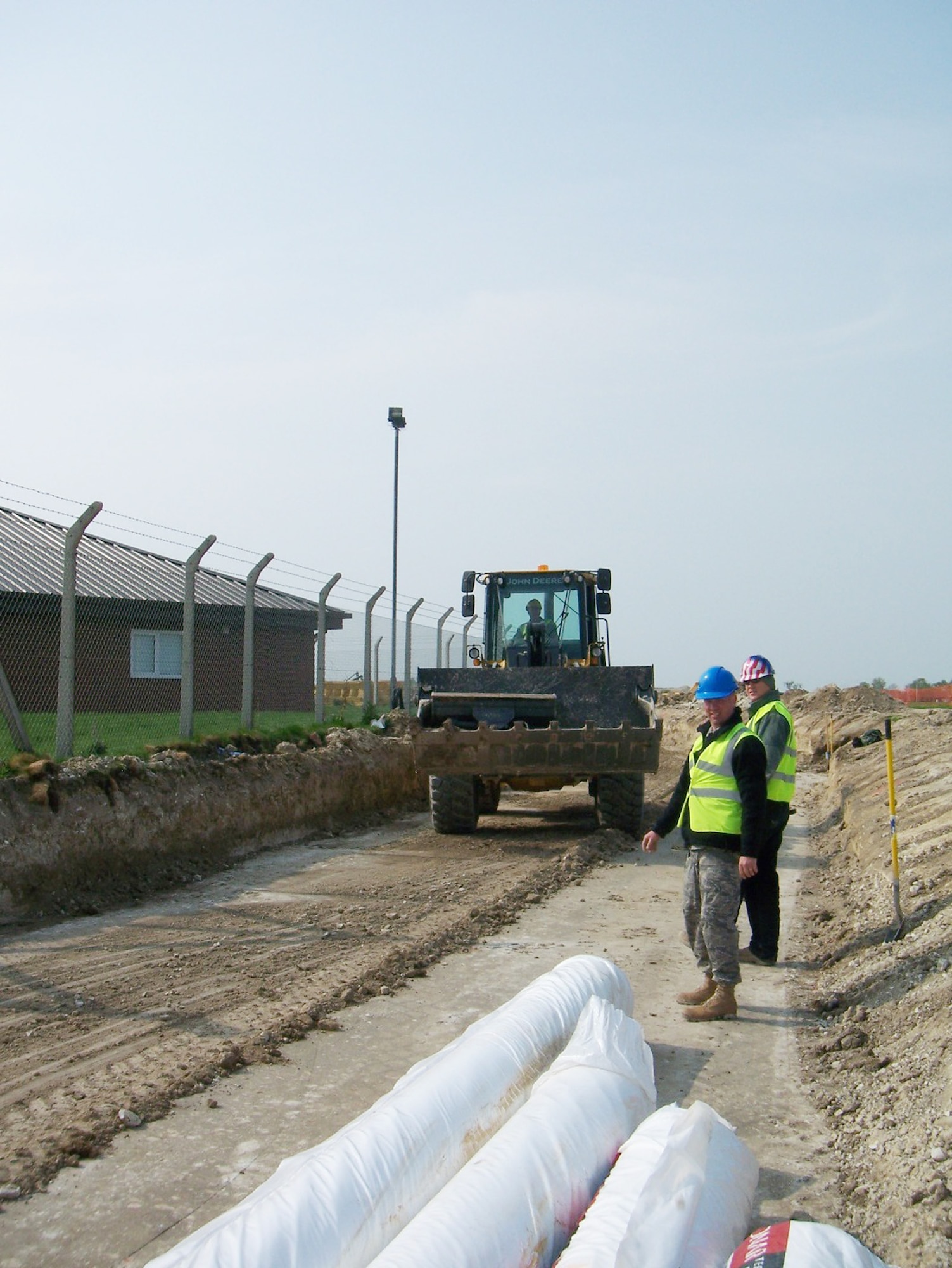 Tech. Sgt. Thomas Riggsbee, Staff Sgt. Raymond Stokes and Staff Sgt. Bobby Martin determine proper width of material during grading operations for a perimeter road in July at Royal Air Force Feltwell, England. Sergeant Riggsbee is the 86th Construction and Training Squadron's Military Construction Flight NCO in charge of structures, Sergeant Stokes is the 86th CTS/MCF NCO in charge of engineering, and Sergeant Martin is a 86th CTS/MCF pavements and equipment operator. (U.S. Air Force photo) 
