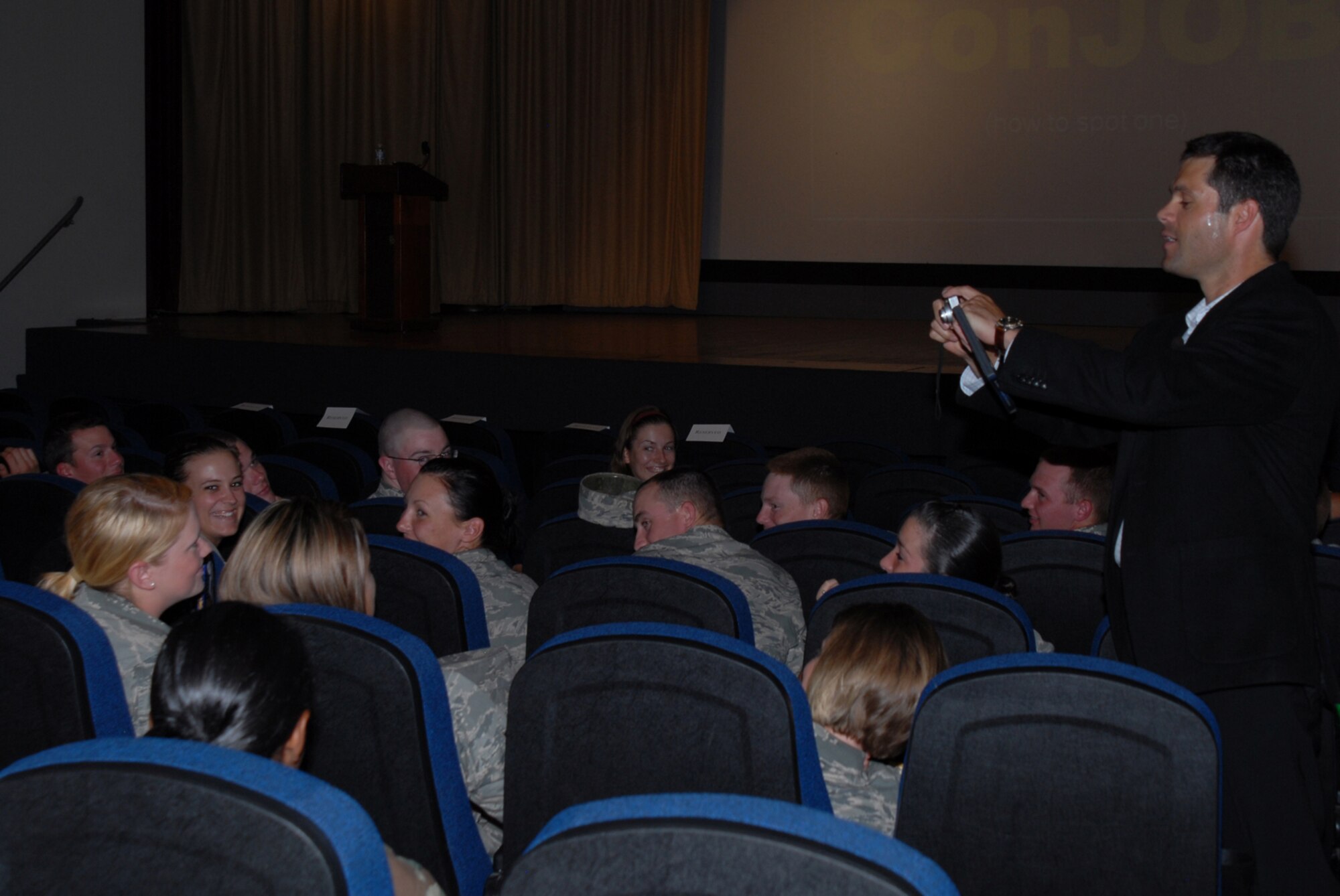 John Sileo, America's Top Identity Theft speaker, takes a picture of an Airman from the 315th Training Squadron at the Financial Readiness Challenge Event at the base theatre. Mr. Sileo demonstrated how easily people can be taken in by identity thieves. (U.S. Air Force photo by Staff Sgt. Laura R. McFarlane)
