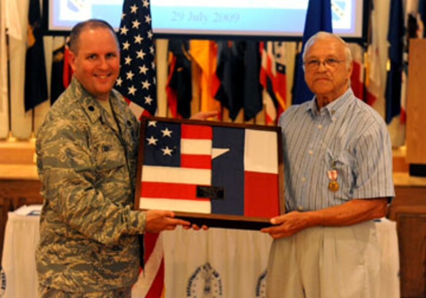 DYESS AIR FORCE BASE, Texas — John Junior Jupin is presented a commemorative gift of the Texas state flag and the nation’s flag by Lt. Col. Christopher Duffy, 7th Civil Engineer squadron commander, here July 29. Mr. Jupin served 23 years active duty and 34 years as a civilian. Mr. Jupin retired from the Air Force in 1975 as a Chief Master Sergeant. (U.S. Air Force photo by Senior Airman Domonique Washington)