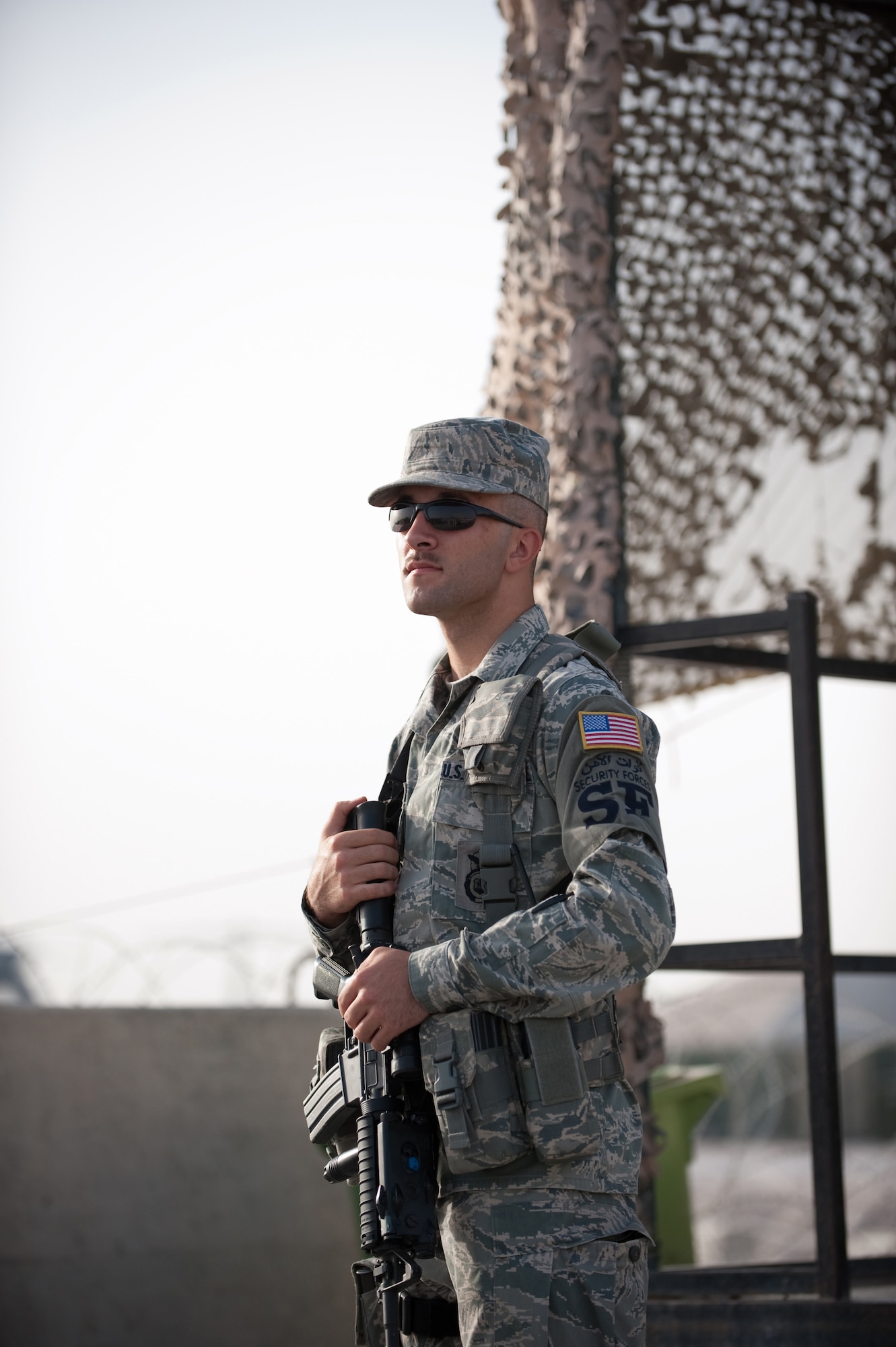 Airman 1st Class Robert Graves, 379th Expeditionary Security Forces Squadron, stands guard over his area of responsibility, July 29, in Southwest Asia. Security forces personnel protect and defend U.S. and Coalition forces serving in support of Operations Iraqi and Enduring Freedom. Airman Graves is deployed from Scott Air Force Base, Ill., and is a native of Wayne, Ohio. (U.S. Air Force Photo by Staff Sgt. Robert Barney)